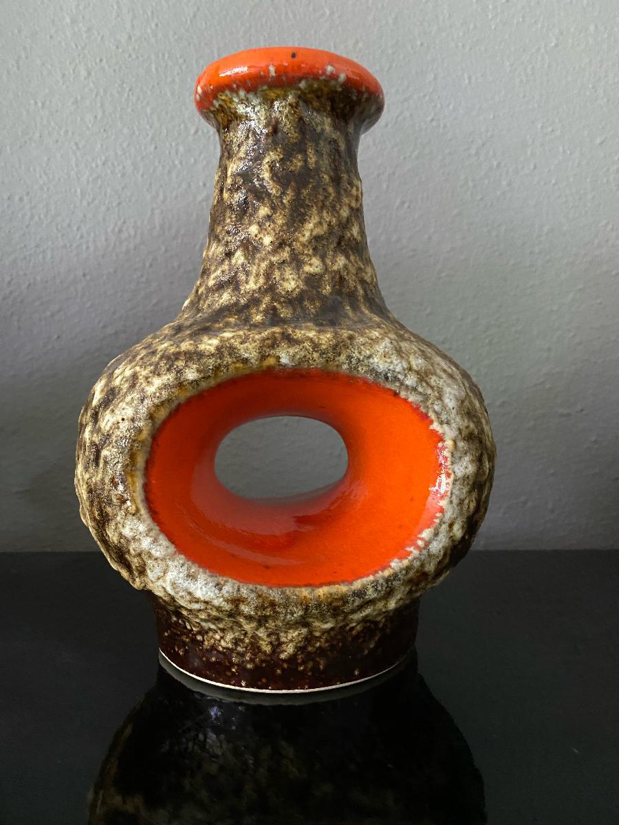 Stunning fat lava hole vase - vibrant orange with crusty thick fat lava glaze in bronze/brown.
According to Mark Hill the quality of Dümler & Breiden pieces is very high, and pieces are often distinguished by their unique, outlandish style with