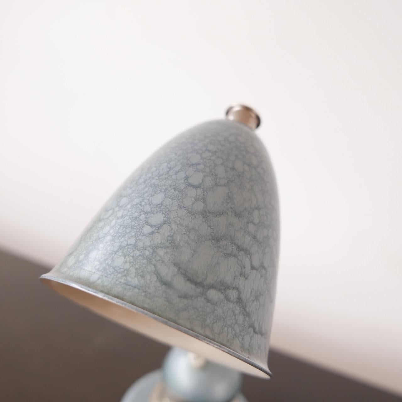 Dutch adjustable ball table lamp. 

Holland, c1950s. 

Painted metal and brass, original blue paint finish in near perfect condition, there is the occasional bit of wear to the paint but very small. 

The light rotates on the ball and at the