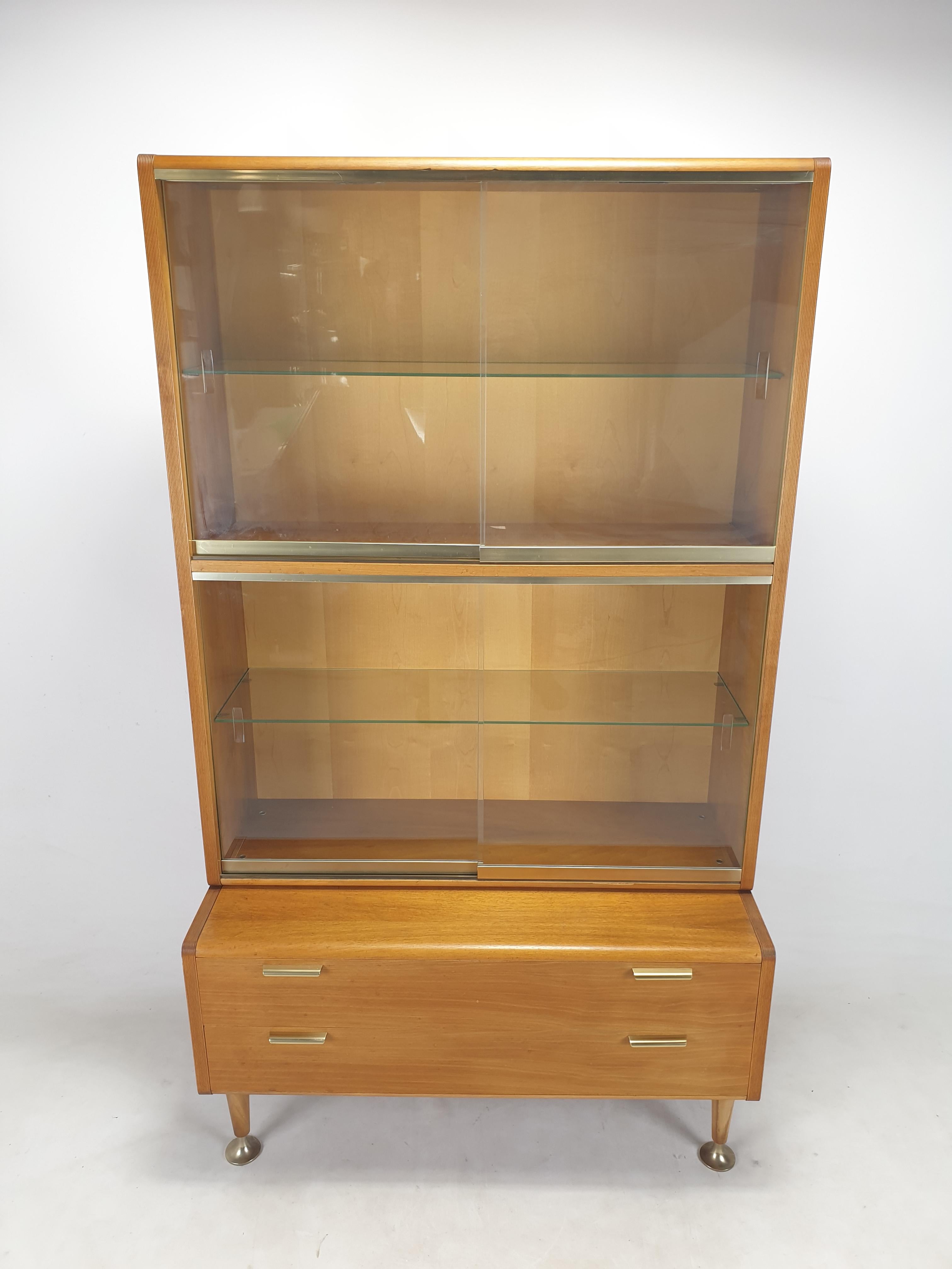 Very nice Dutch walnut cabinet, designed by A.A. Patijn for Zijlstra Joure in the 50’s. 

This high quality cabinet is composed by 2 modules. 
One is equipped with two shelves, the other big size with glass. 

It has brass details and it is