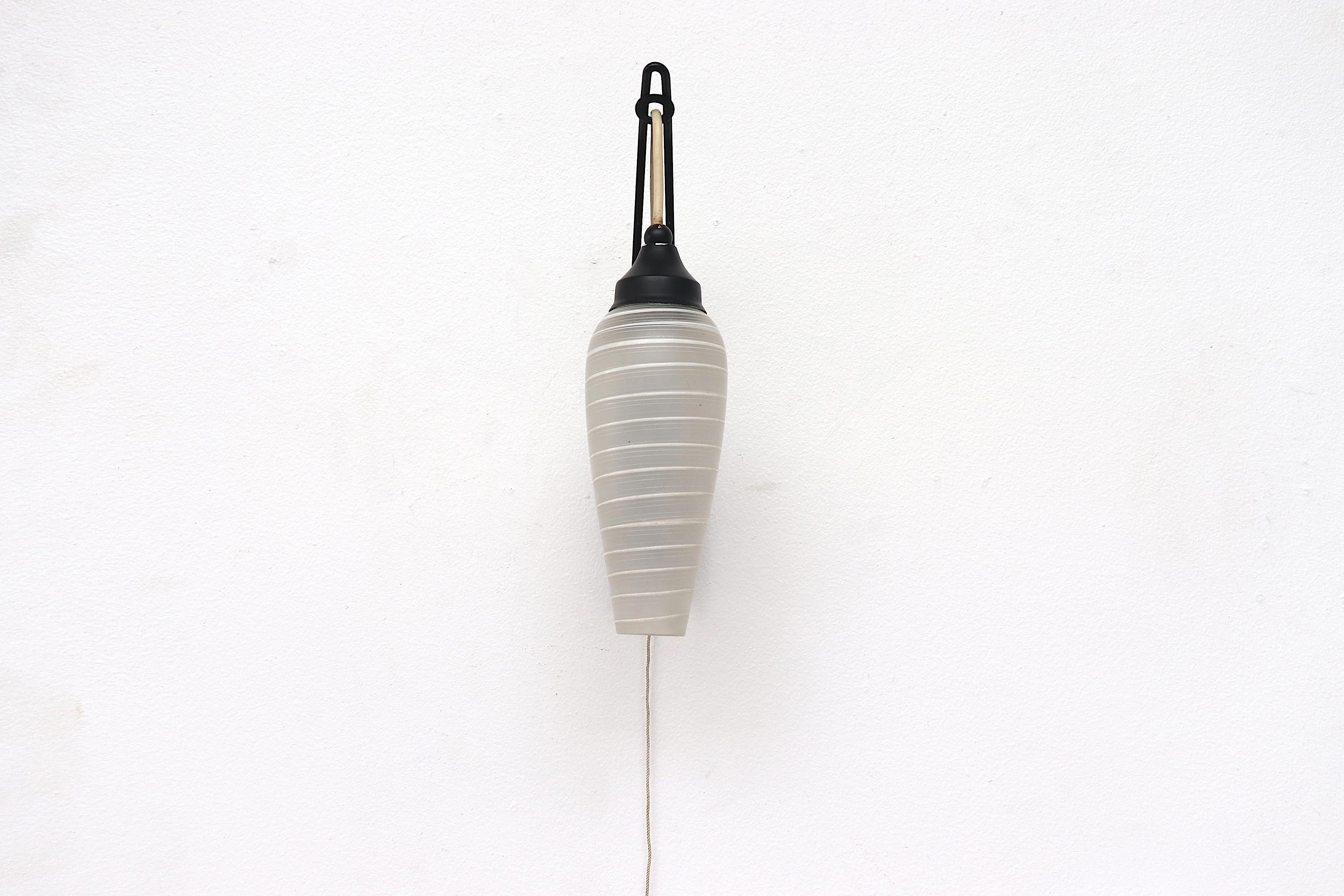 Midcentury Dutch hanging wall sconce with striped milk glass shade and black enameled base. Fishing pole style lamp in good original condition.
