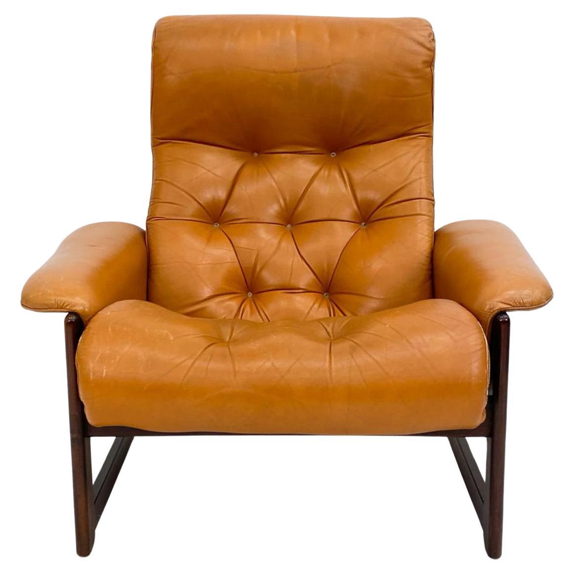Mid century Dutch modern tufted leather lounge chair and ottoman. Made circa 1970 has Cognac-tone tufted leather chair and ottoman. Solid Beech wood frames with dark brown stain. Shows little wear from use otherwise very good condition. Sold as a