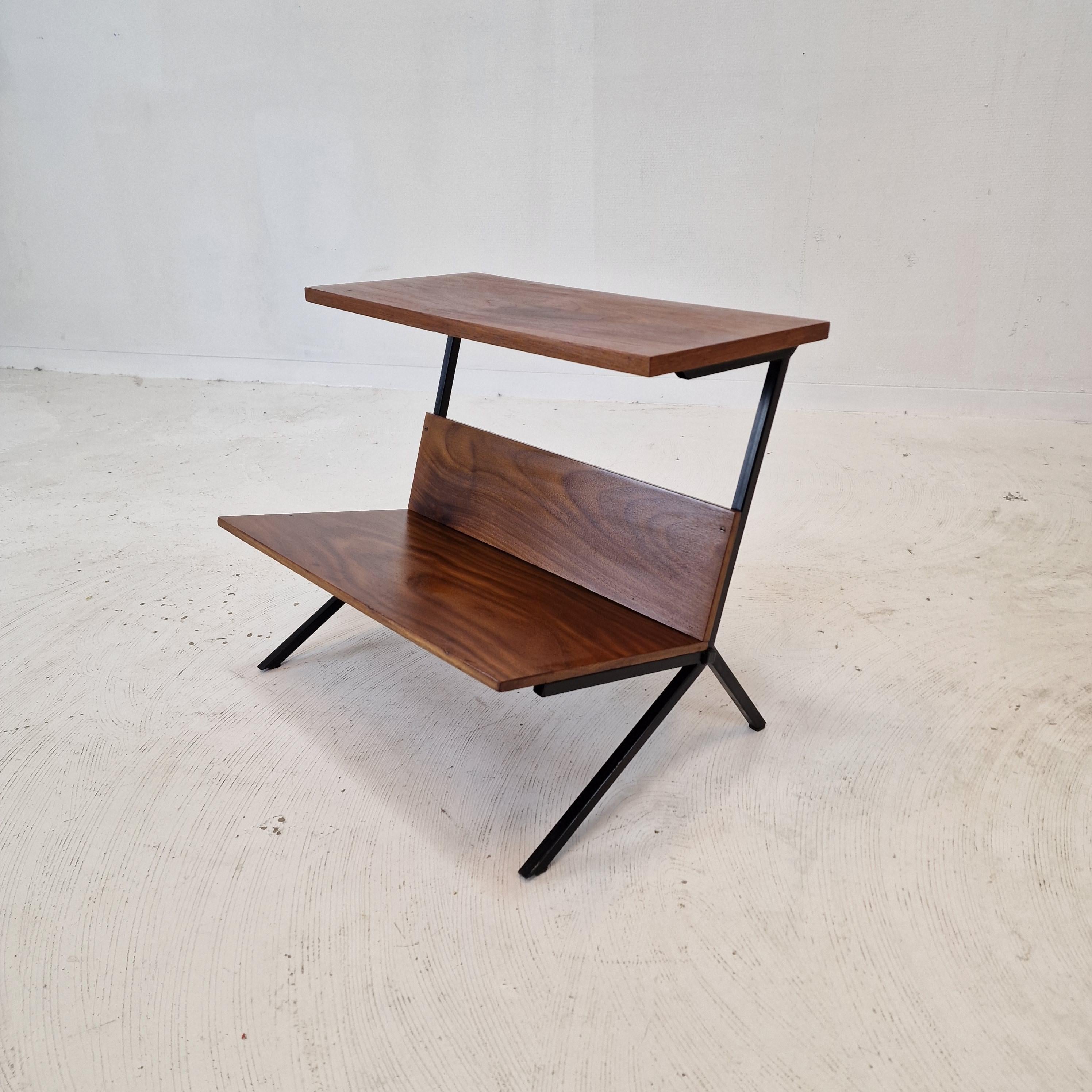 Very nice Dutch side table with magazine rack, fabricated in the 60's. 

It is made of teak veneer and a black painted metal structure.

We work with professional packers and shippers, we can deliver worldwide in 5 to 10 days.