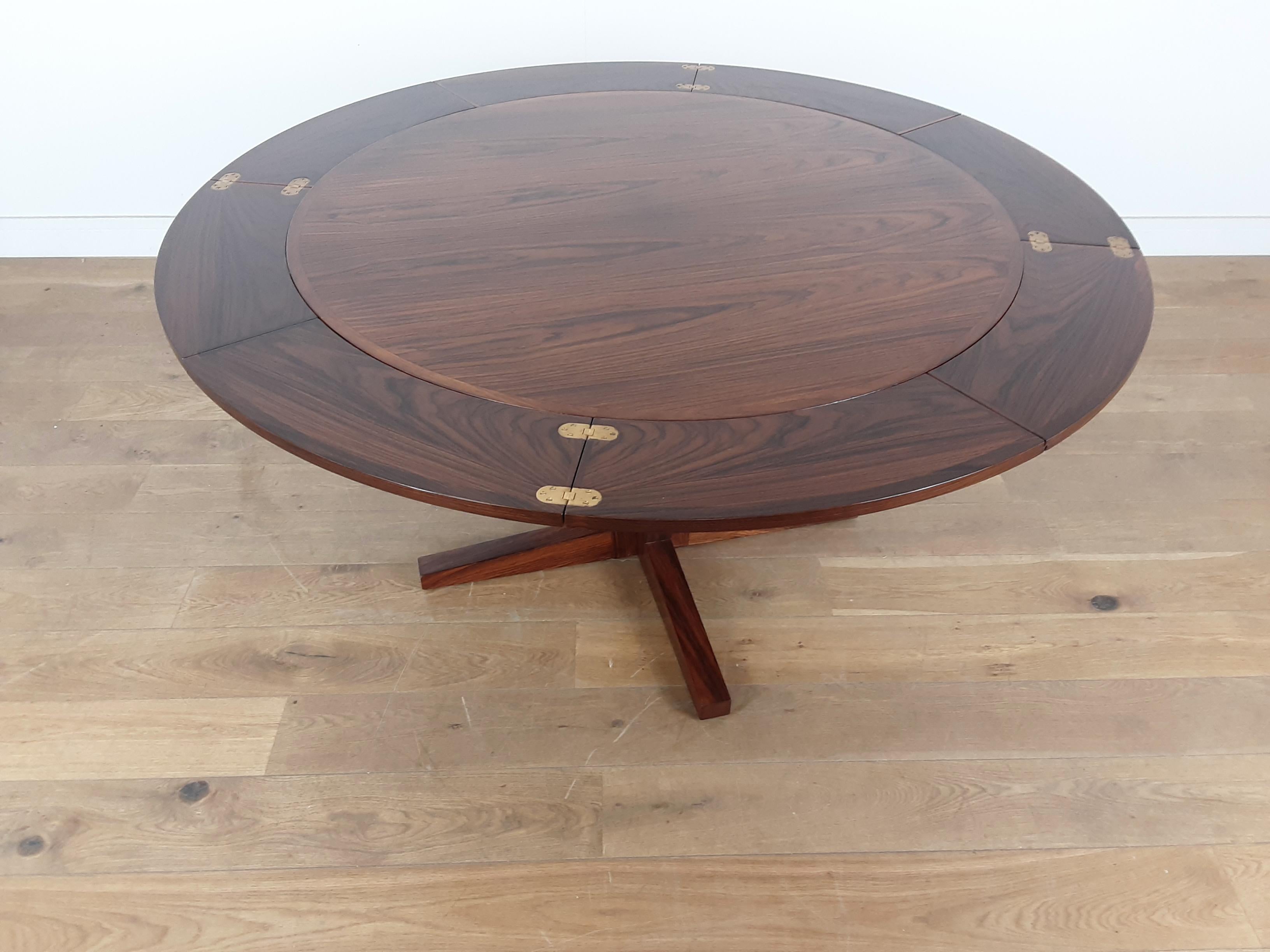 Danish Mid-Century Modern design at its best.
beautiful Brazilian rosewood extendable dining table designed by Dyrlund Smith.
Know as the flip flap table due to its 4 extension leaves which slide out from underneath, each with inset brass hinges