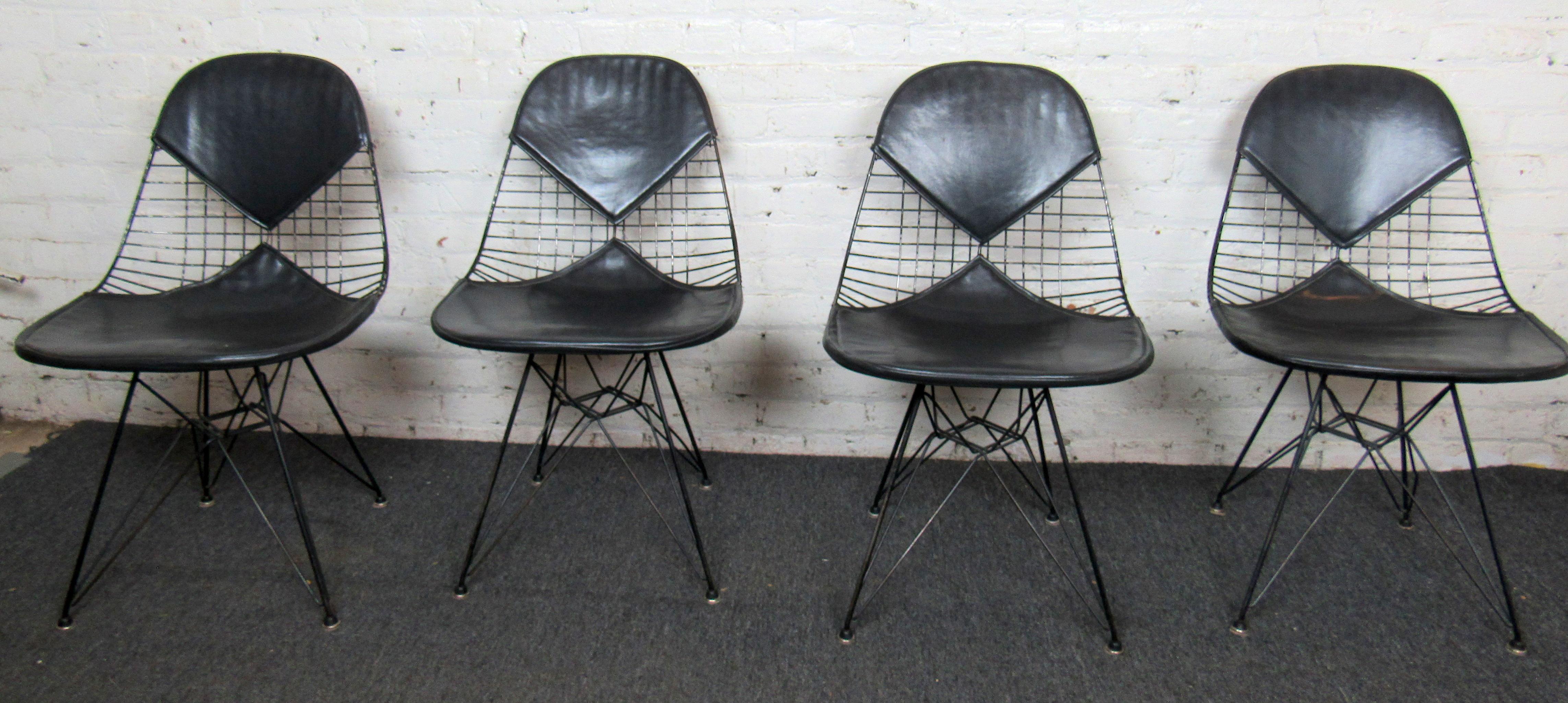 Set of four wire chairs by Charles Eames for Herman Miller. Complete with naugahyde black 