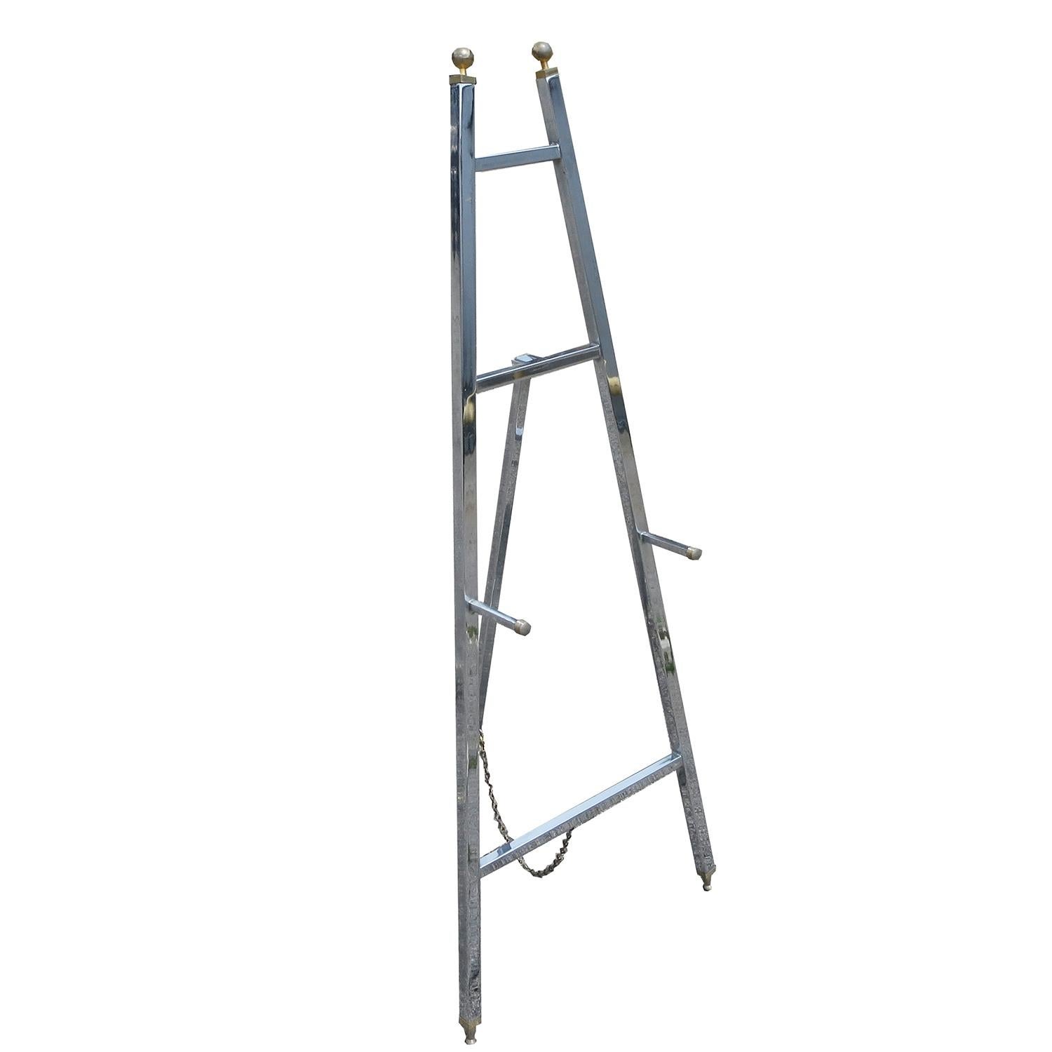 Want to display your art in a stylish, modern way? This fantastic easel will highlight any work without distracting from the art. The easel is hollow chrome-plated steel tubes, capped with brass finials and feet. The chain allows for a great range