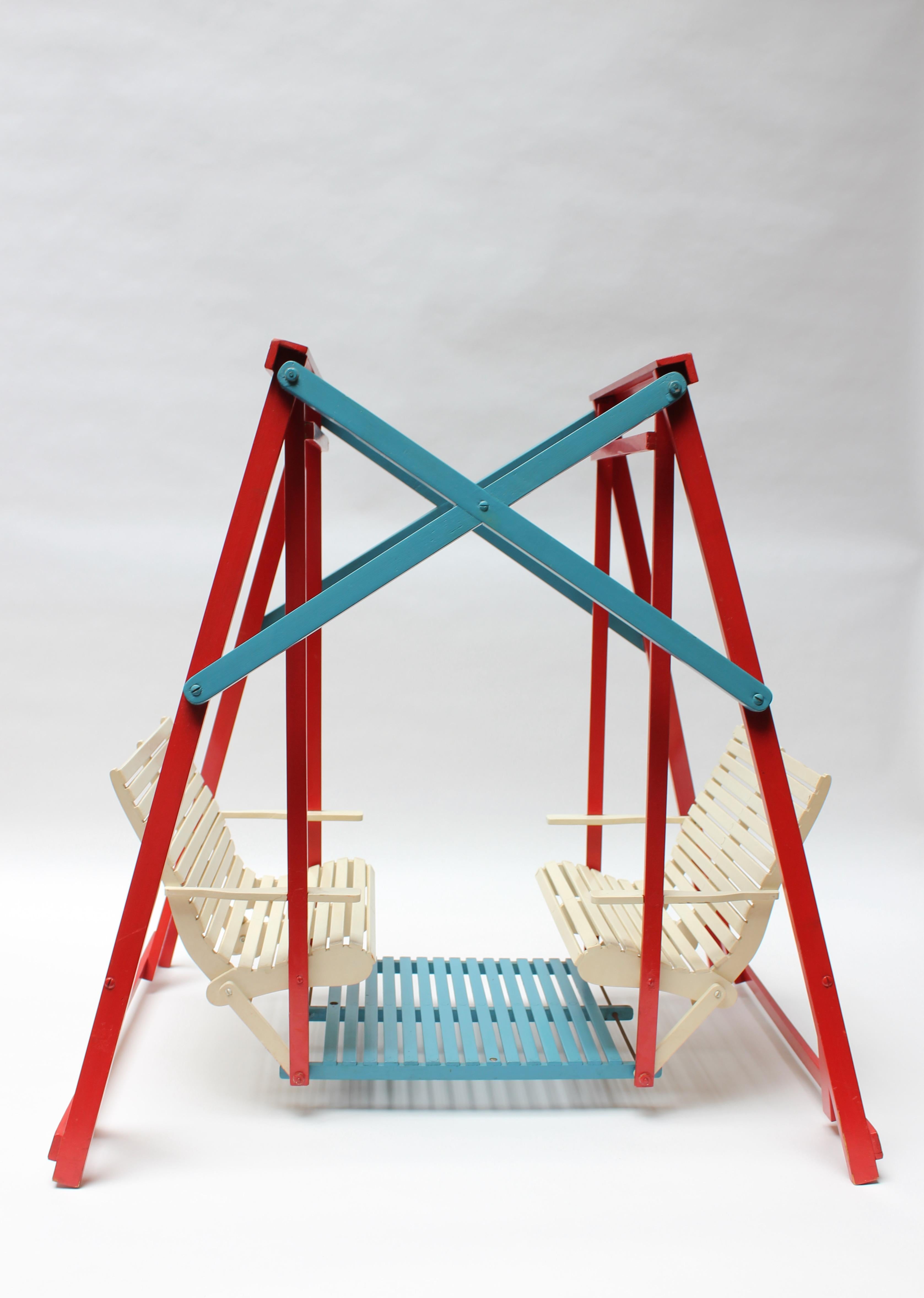 Miniature Easi-Bild lawn glider (likely a Salesman Sample advertising the sale of the instructional manual for the full size model). 
Attractive color combination of red, white, and blue with very little wear, given its age and use (spots of paint