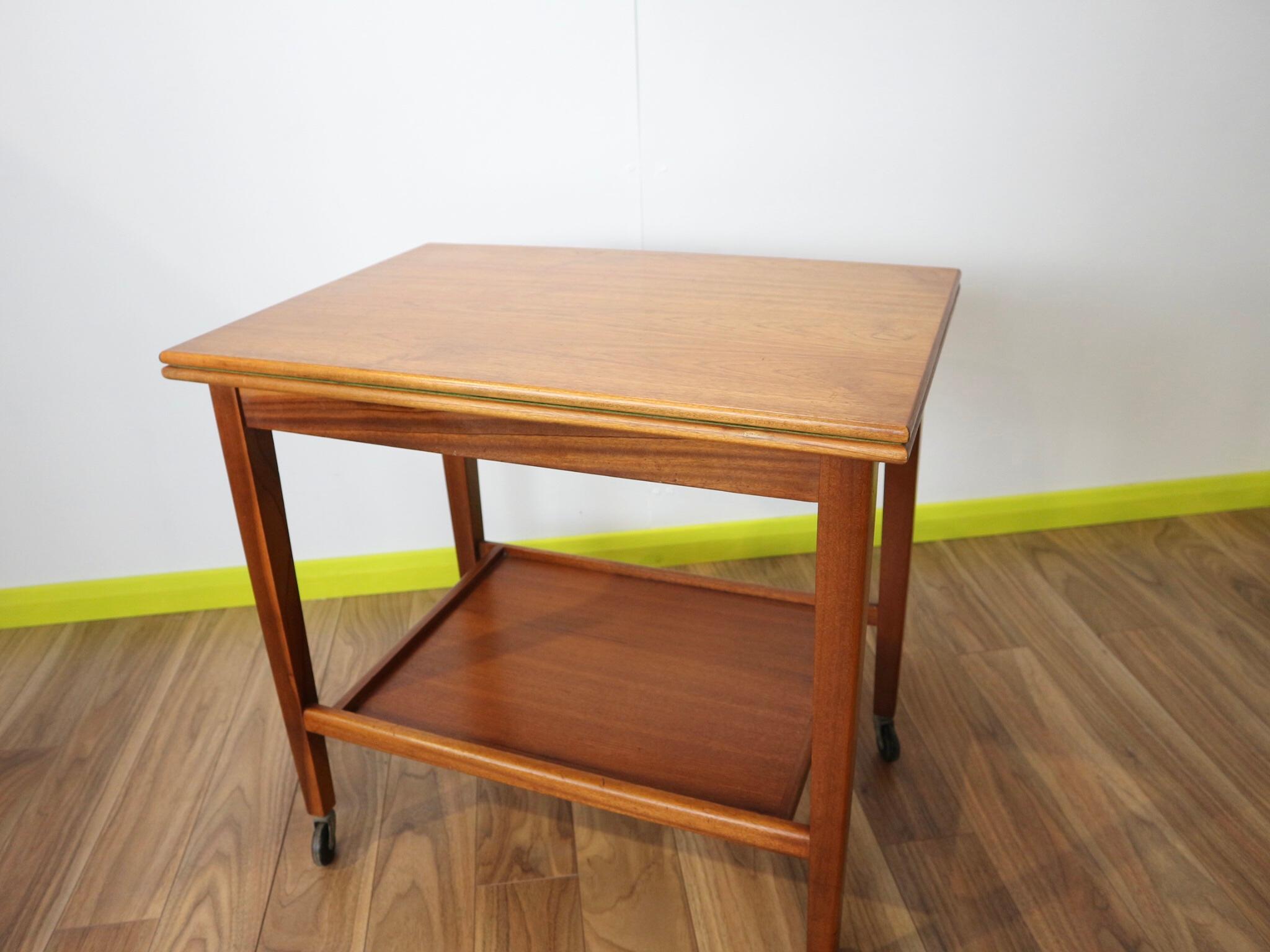 A delightful mid century teak card games table made by Eastcraft of Scotland. A clever fold out top table, fully felted in green, felt in good condition. The top opens and turns to reveal a drawer space for keeping cards, dice, domino's etc. The