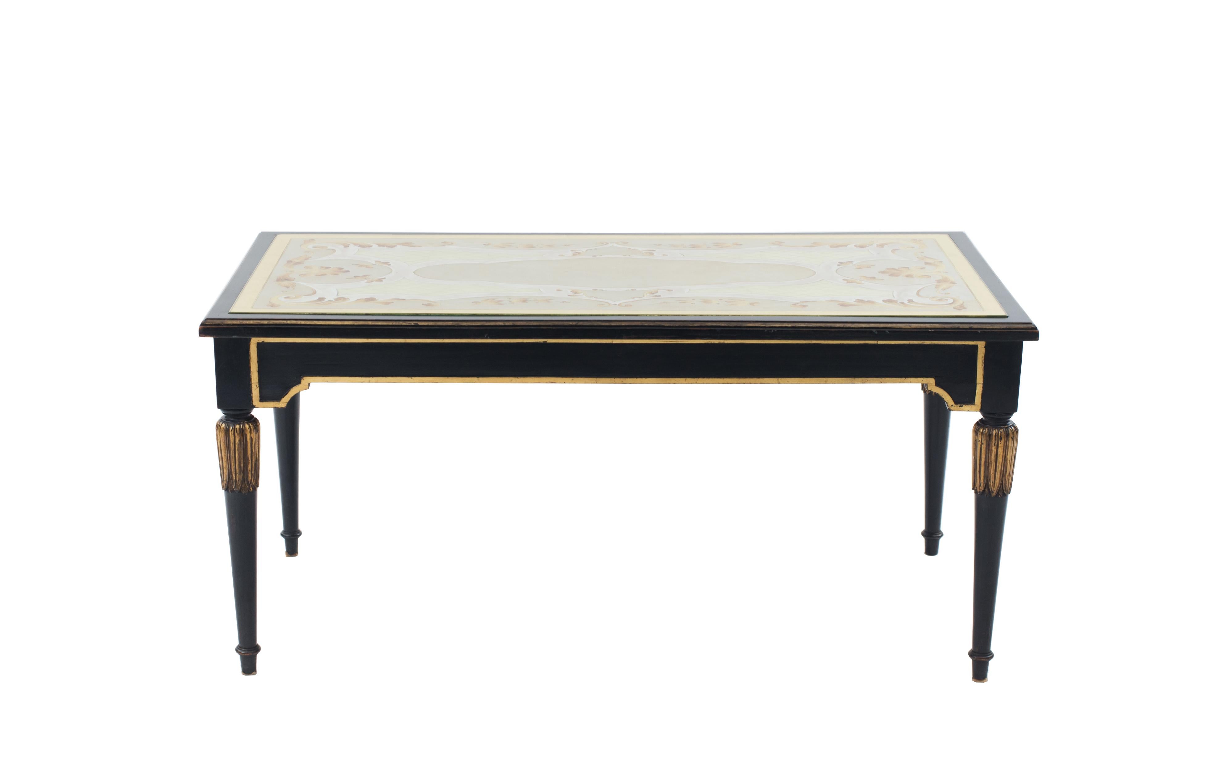 Mid-Century (circa 1950) ebonized coffee table with an √©glomis√© top resting on tapered legs with gilt detail (attributed to: MAISON JANSEN)
