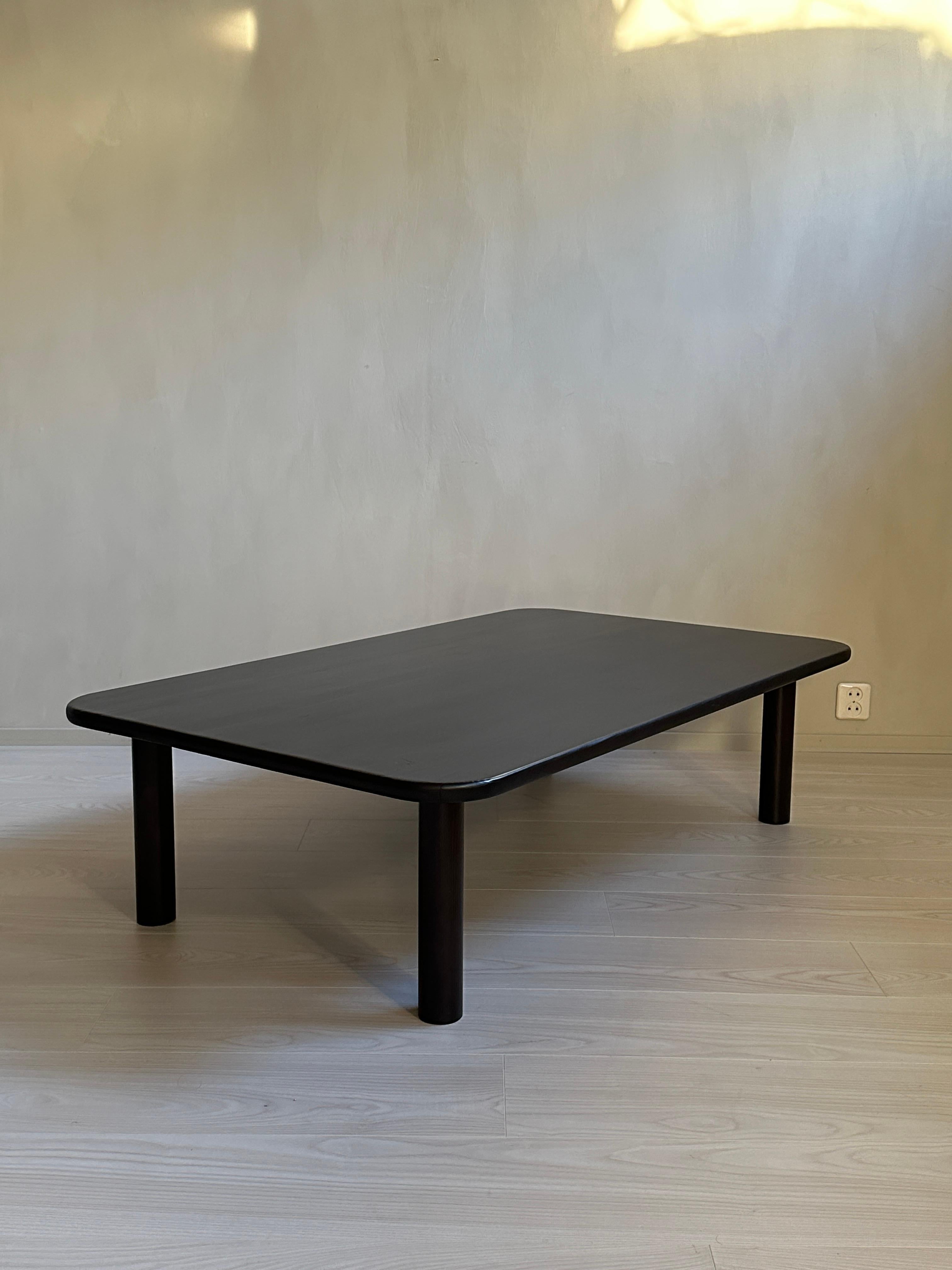 This beautiful Mid-Century Modern ebonized coffee table is a true piece of art and history. Designed in Scandinavia during the 1960s by an unknown designer, it is made from massive pine and features a unique ebonized finish that will suit any living
