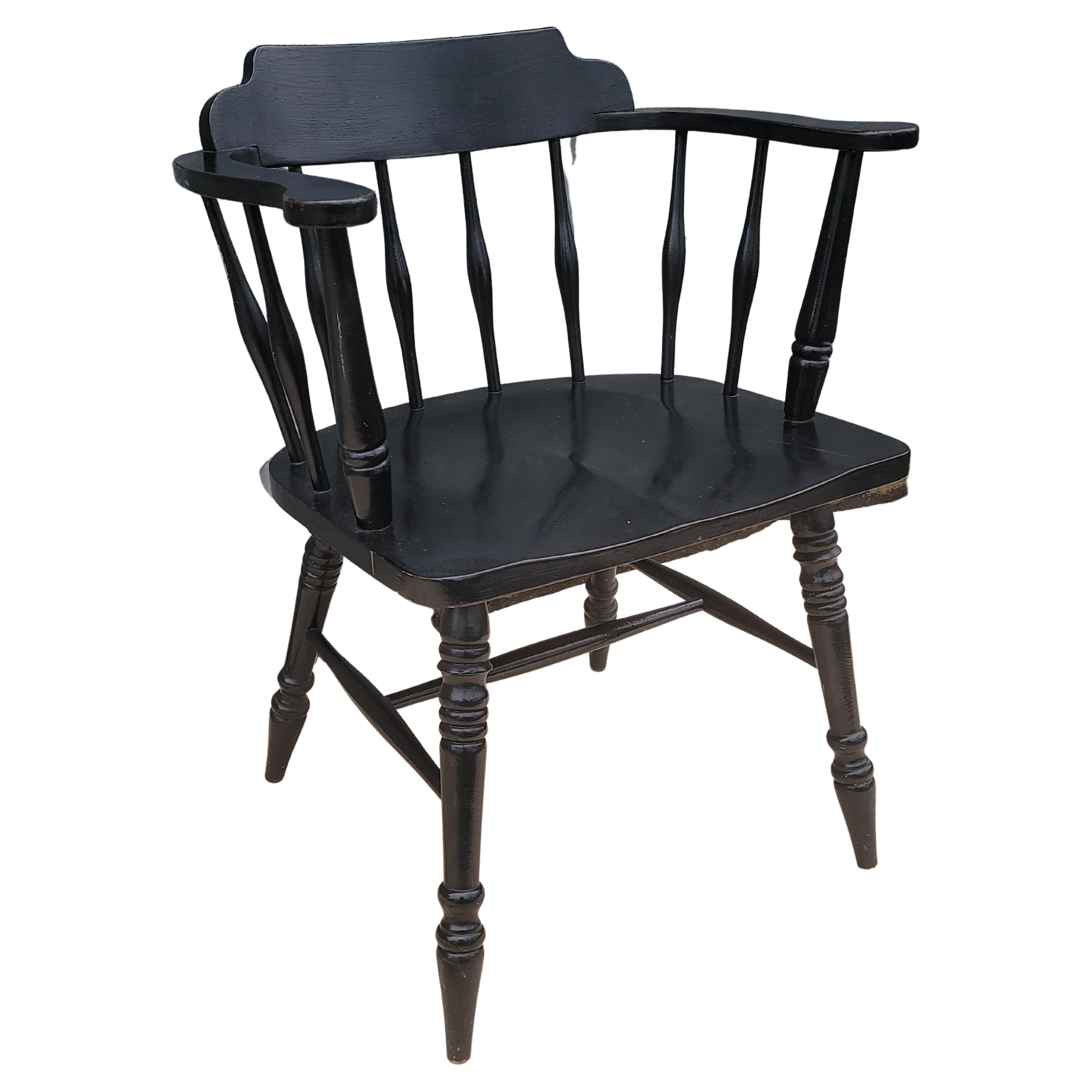 A mid-century ebonized oak lowback windsor chair. Measuring 24