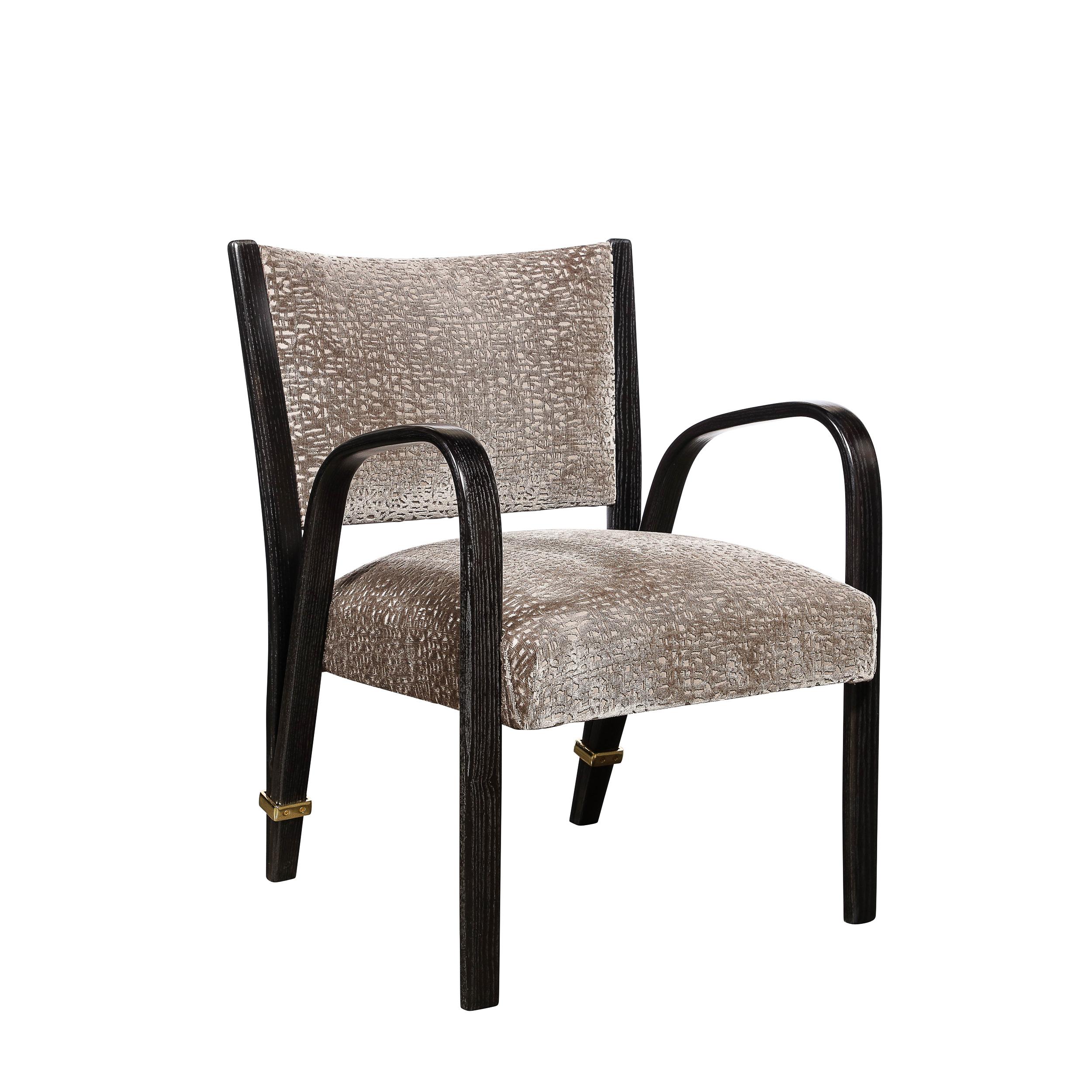 This stunning pair of Mid-Century Modern spring back chairs were realized by the esteemed designer Hughes Steiner in France circa 1950. They offer a graphic form with a dramatically arched arm rests that descend into straight front legs. The bent