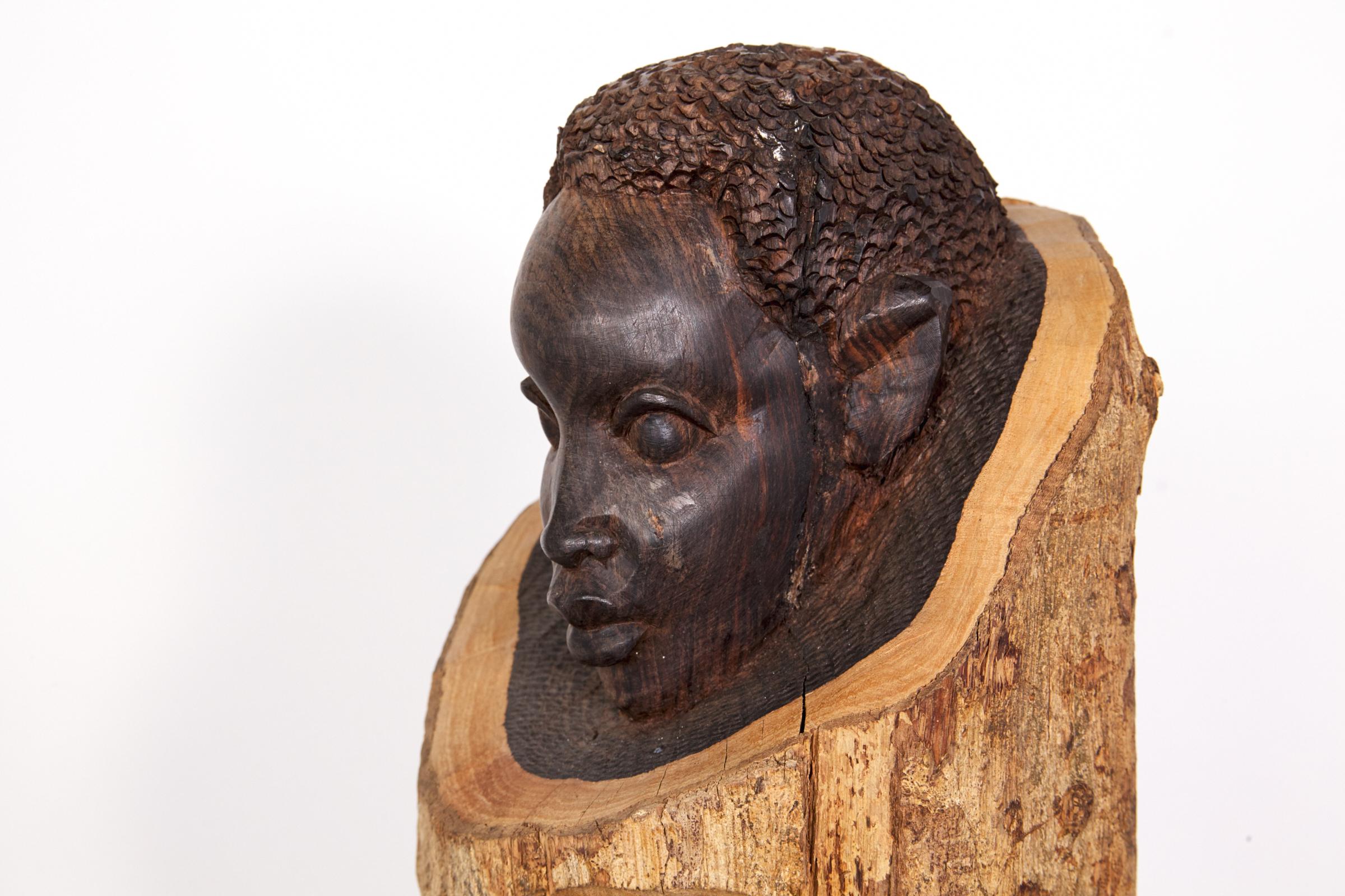 A wonderful solid, ebony wood, hand carved, Artist-signed, sculpture (Signed on bottom right of base) by Hadisi Kalenda. An exceptional work of art depicting the essence of the 