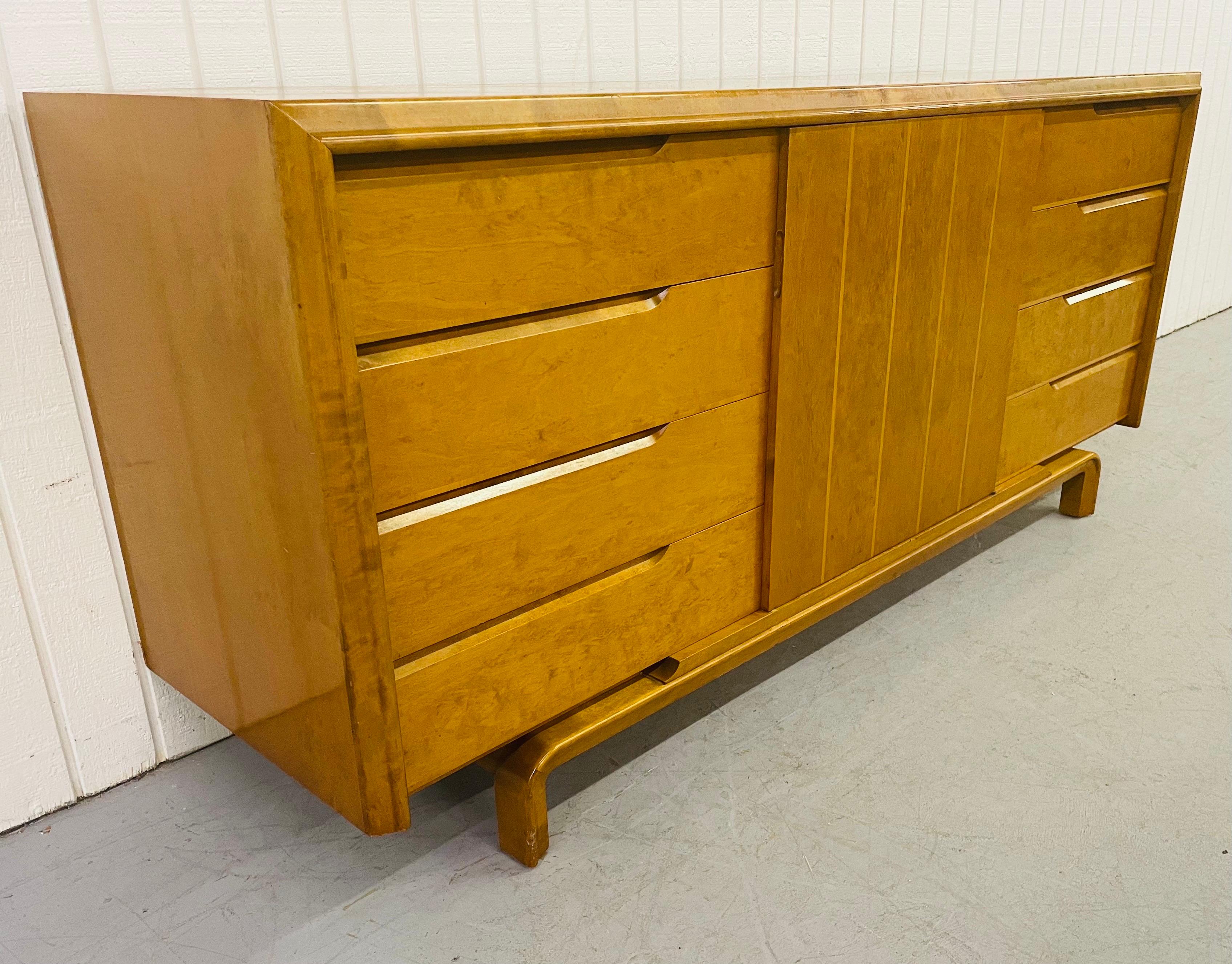 This listing is for a mid-century Edmond Spence dresser. Featuring a center door that opens up to storage space, eight drawers, and a beautiful champagne blonde finish.