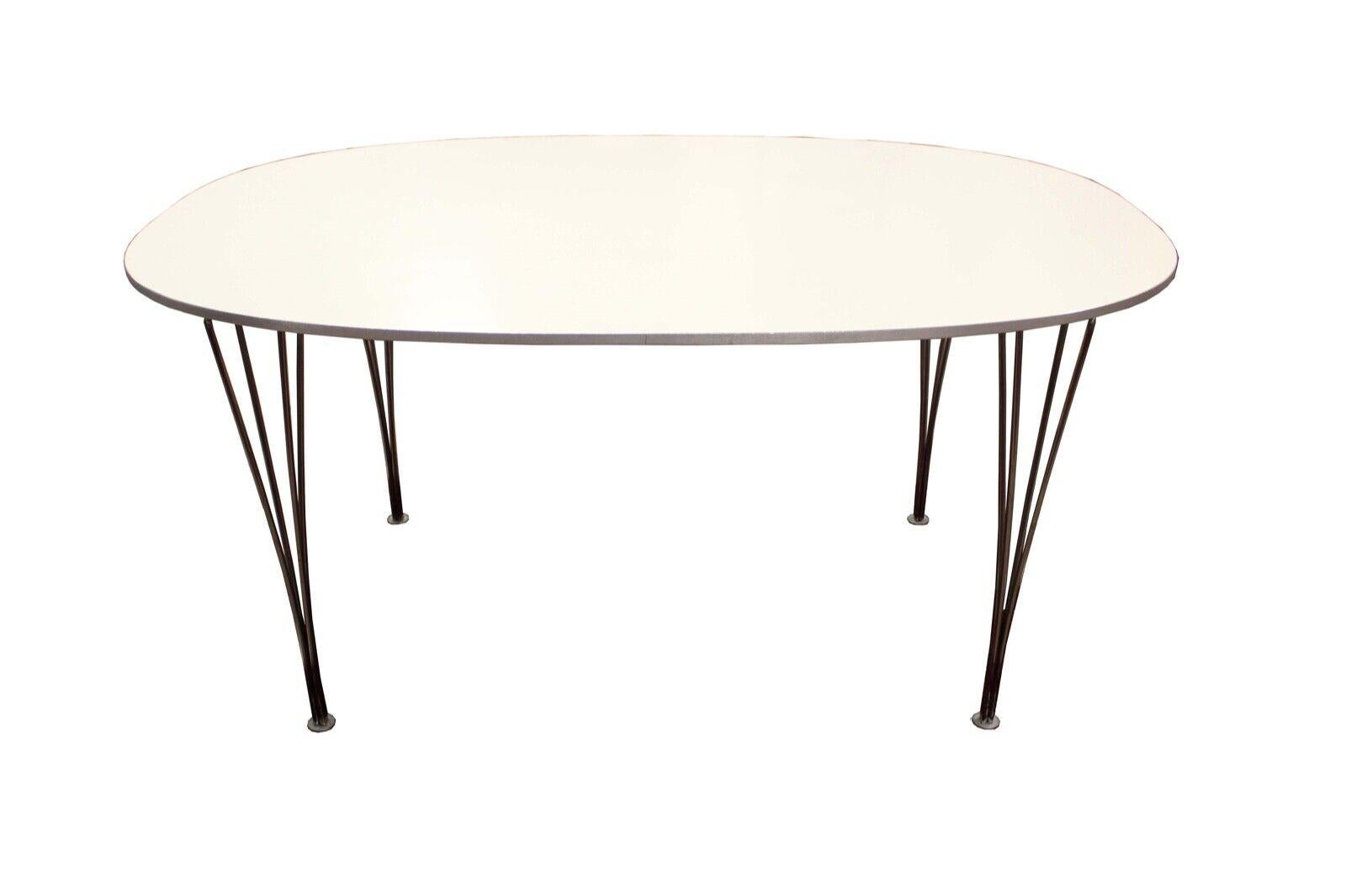 Le Shoppe Too presents an ellipse dining table with white laminate designed by Piet Hein and Arne Jacobsen, and manufactured by Fritz Hansen in 1998. In very good condition. Dimensions: 59