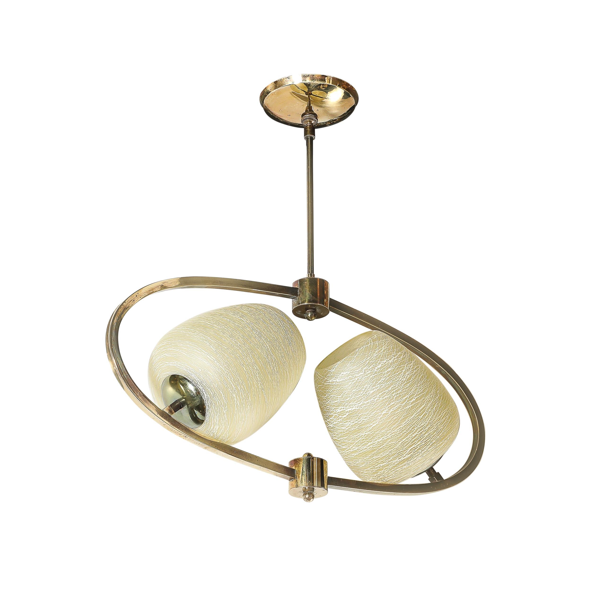 This elegant Mid-Century Modernist elliptical chandelier, crafted in Italy circa 1960, showcases sleek design and exceptional craftsmanship. Its elongated frame in antiqued brass exudes a warm patina, enhancing its timeless appeal.

Inside the