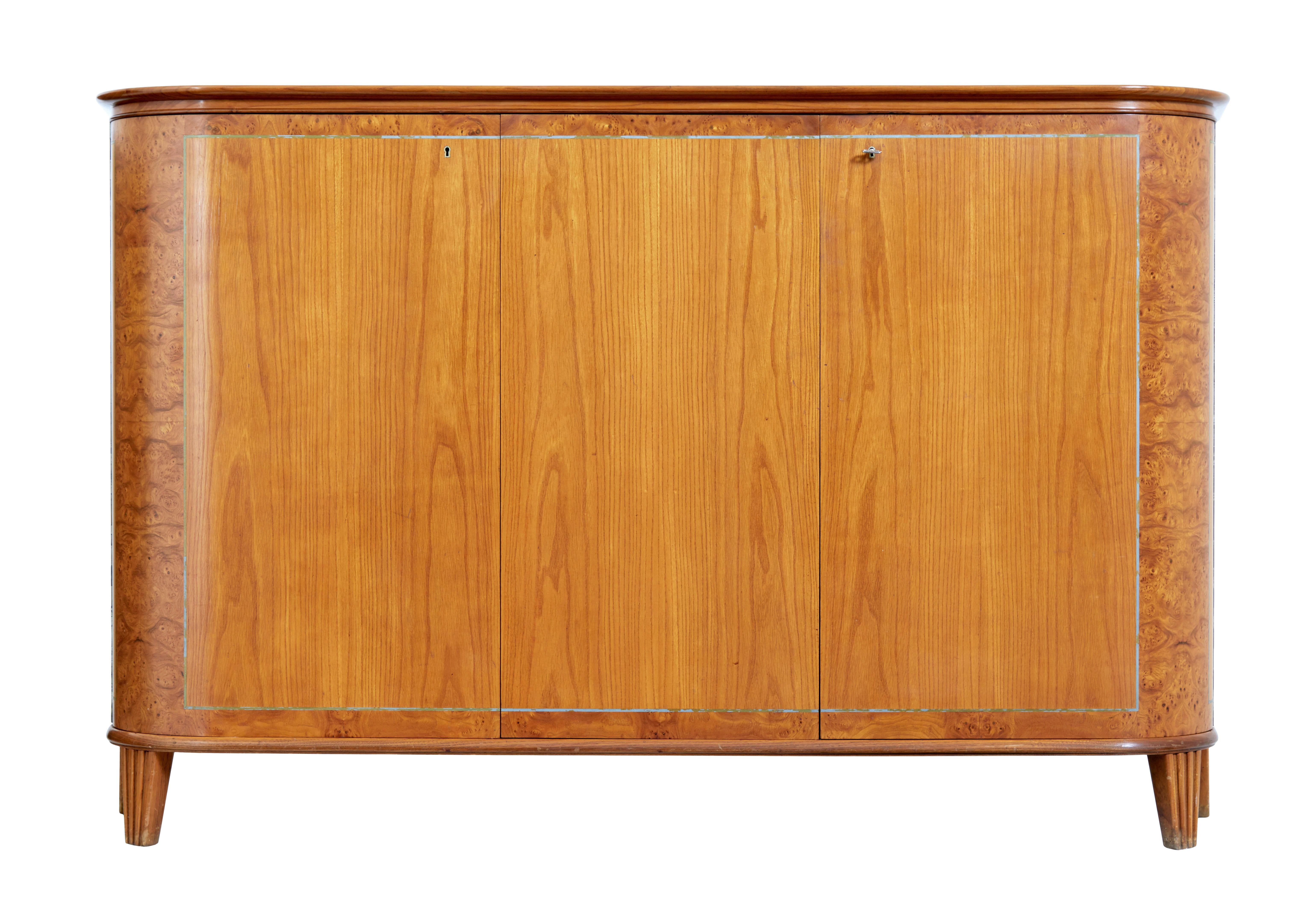 Midcentury elm sideboard by Thysells Mobler circa 1950.

Popular model by well know maker Thysells Mobler , this sideboard being different from the norm being made in elm with masurian birch cross banding.

Rounded shaped top surface with
