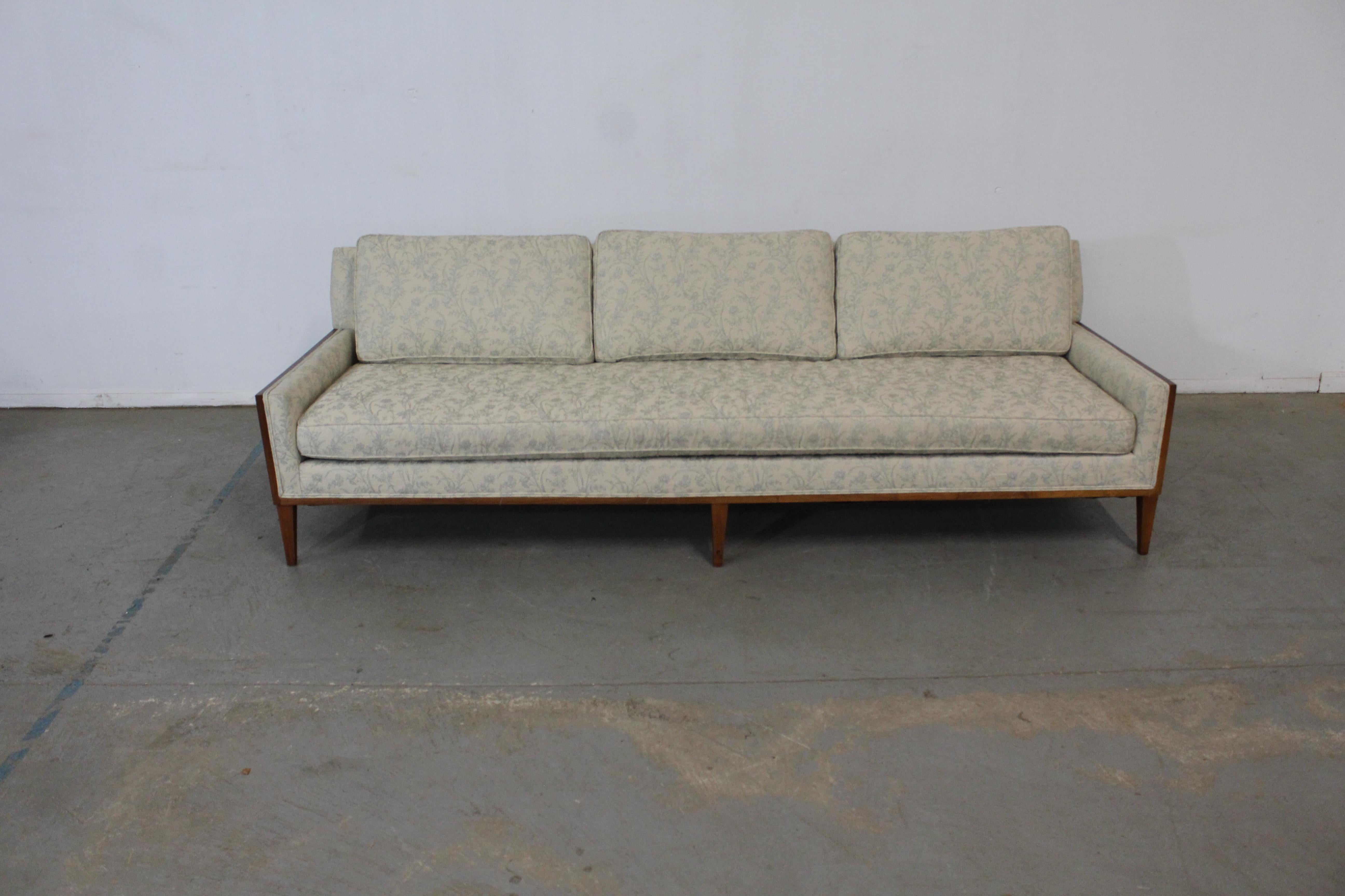 Mid-Century Elongated Low Profile Walnut Trimmed sofa on Tapered legs
Offered is an unrestored mid-century modern sofa. This sofa is very cool and has nice lines. The design screams 1960's and gives off a total James Bond era vibe. Sleek would be a