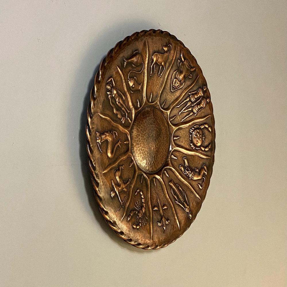 Midcentury embossed copper zodiac plaque is a product of the storied region of Dinant, now in Belgium, where talented metalsmiths have practiced their art for centuries. The official French name for the work was Dinanderie which was practiced at the