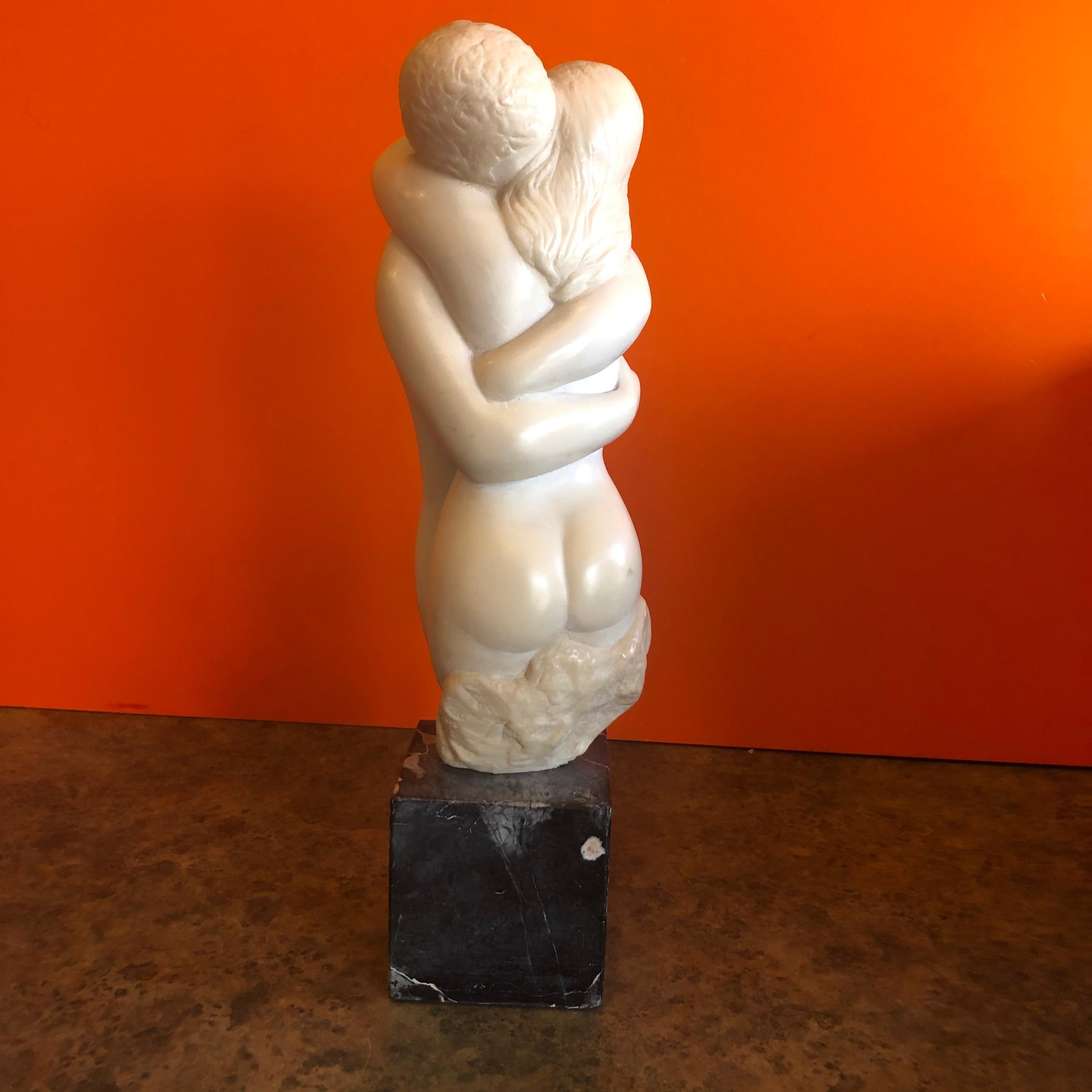 Midcentury embracing nudes resin sculpture on marble base by Peggy Mach for Alva Museum Reproductions (AMR), circa 1970s. The piece is very heavy, well detailed and signed. Overall, the piece measures 4