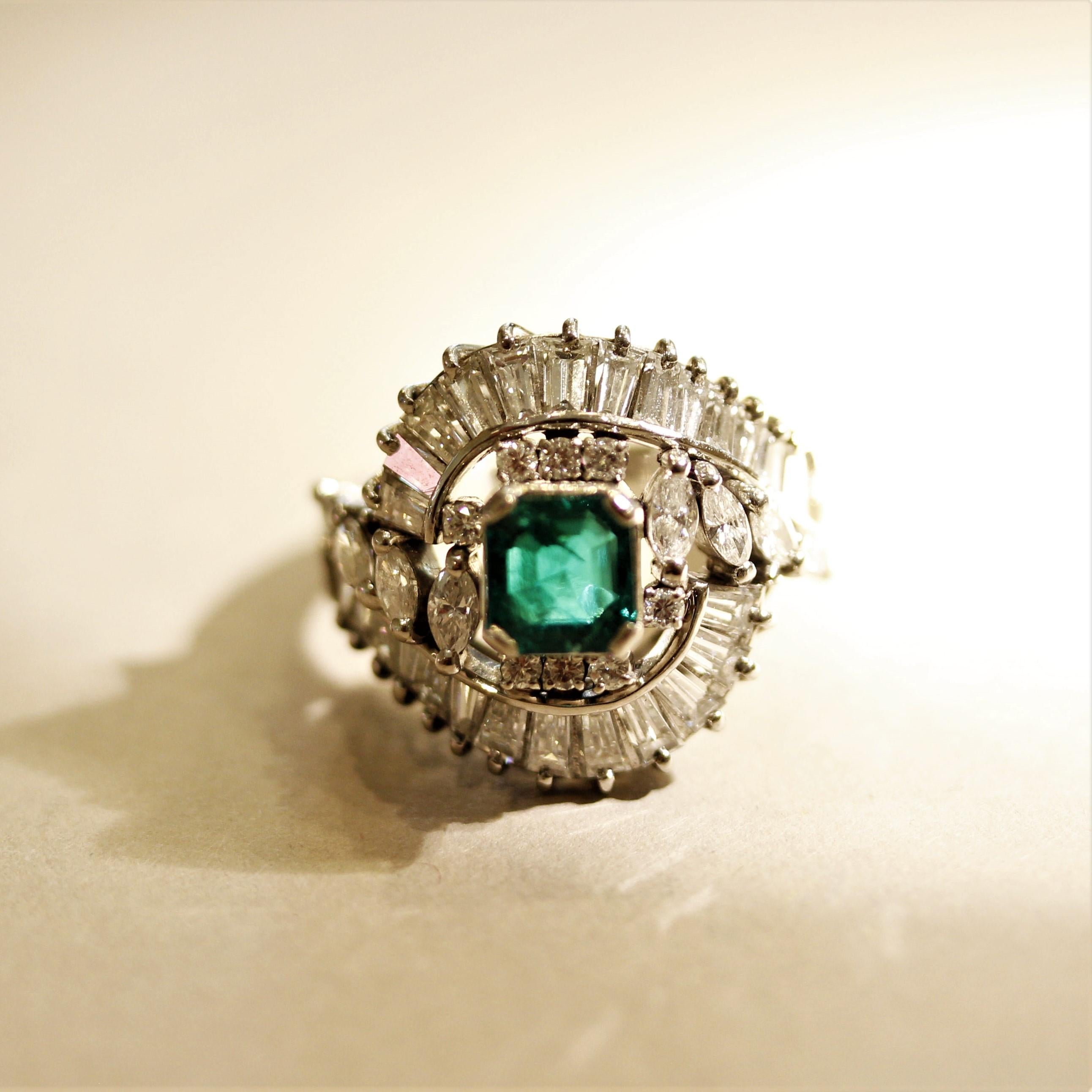 A superb ring in terms of the quality of the stones as well as the classy design. This mid-century treasure, circa 1960’s, features a gem 1.35 carat square-shaped emerald with a vivid grass-green color and is free of any large visible inclusions