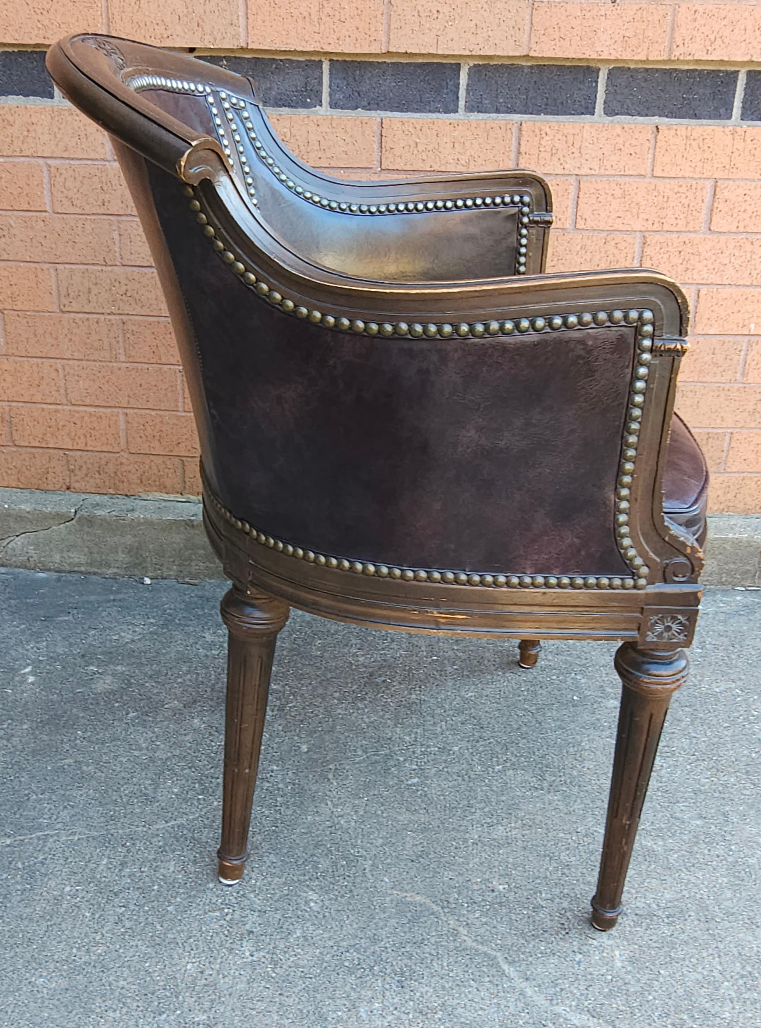 A Mid Century Empire Style full grain Leather Upholstered and Nailhead Studded Mahogany Arm Chair. Measures 22