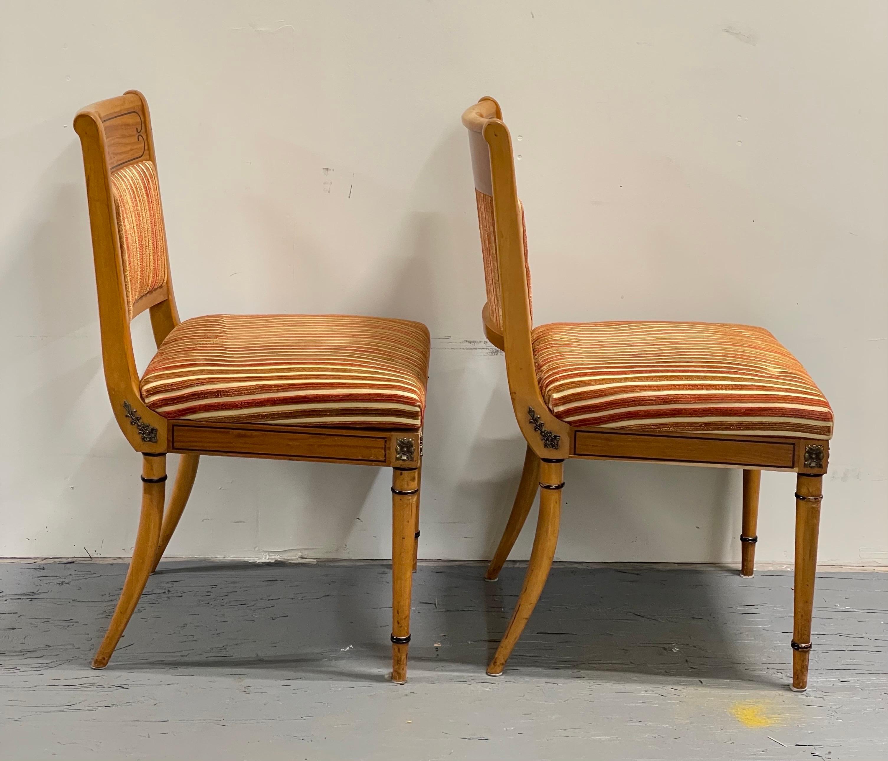 Vintage chairs with all the bells and whistles. Great lines and attention to detail with brass emblems and black outline accent. Sleek curves complement this classic design.