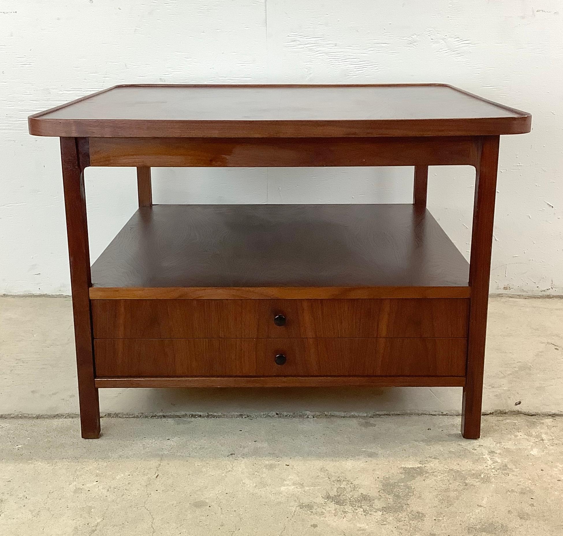 Embrace the timeless allure of mid-century design with this exquisite end table, attributed to the creative genius of Jack Cartwright for Founders. Its seamless blend of form and function exemplifies the best of vintage modern furniture, offering a