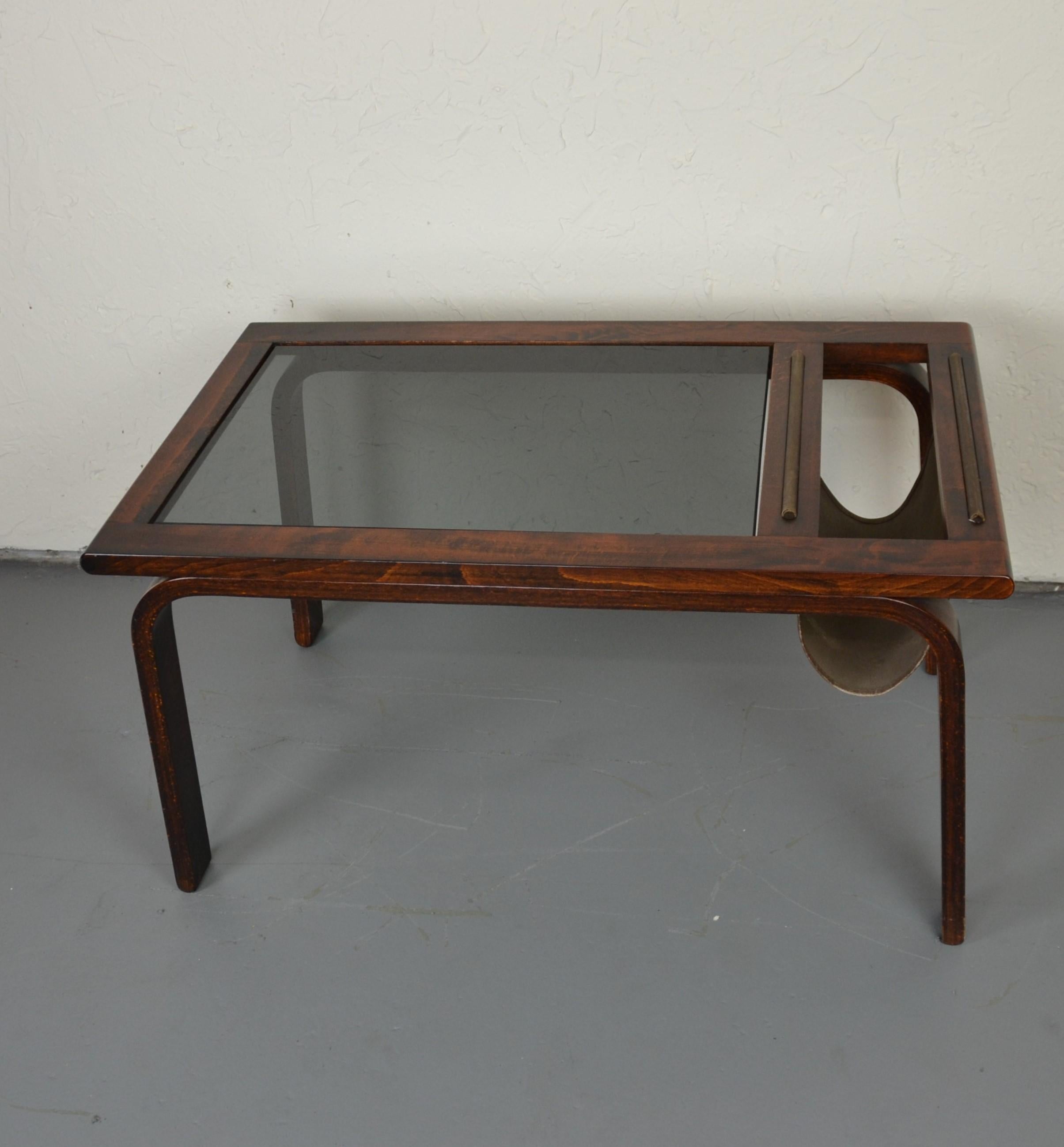 Mid-century glass top end table with magazine rack.