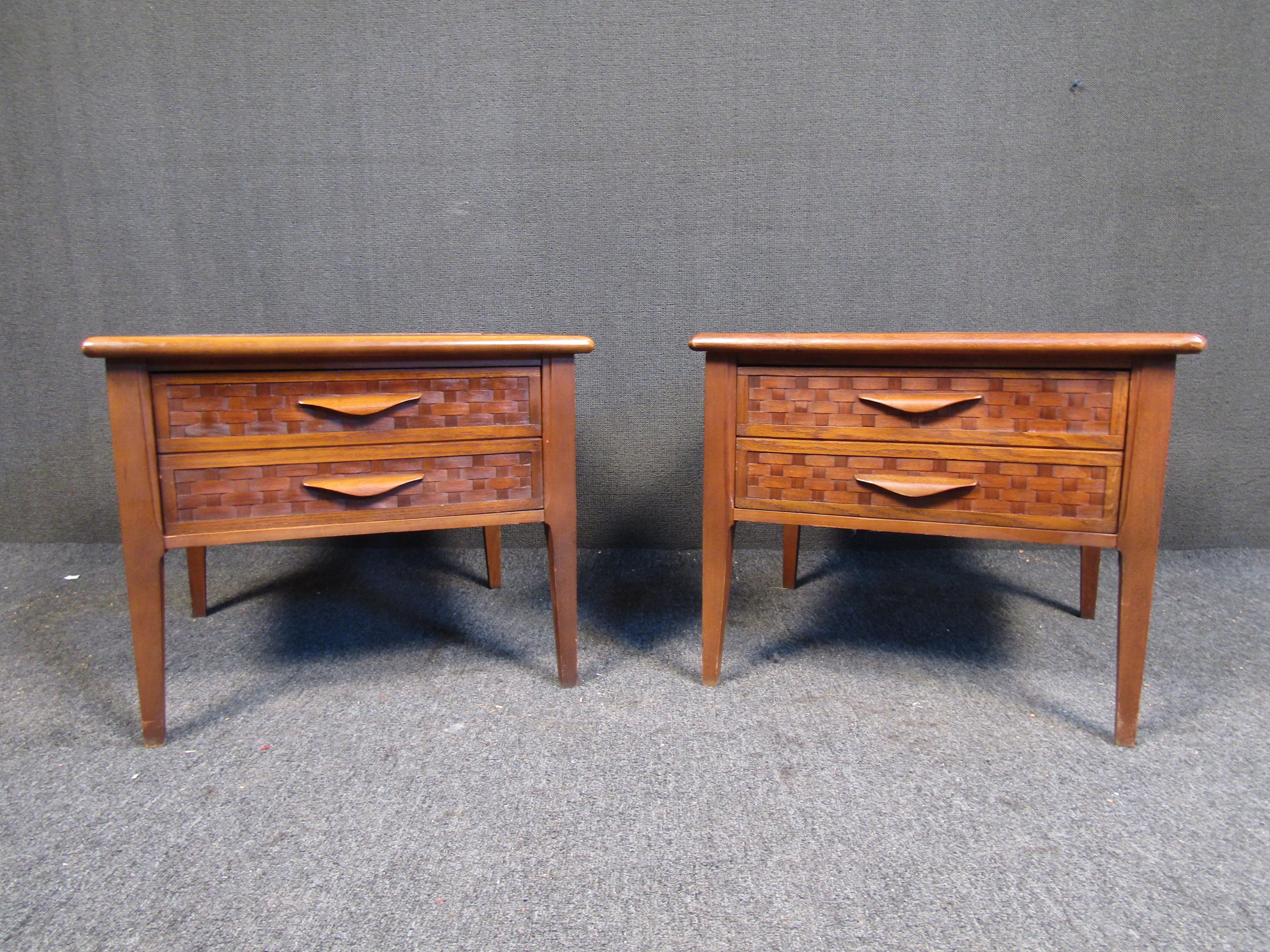 Mid-century end tables by Lane. This elegant side tables feature a walnut/oak construction, stone inserts, tapered legs and an ornate basket woven style drawer face. The deep drawers are perfect for storing odds and ends! A perfect addition to any