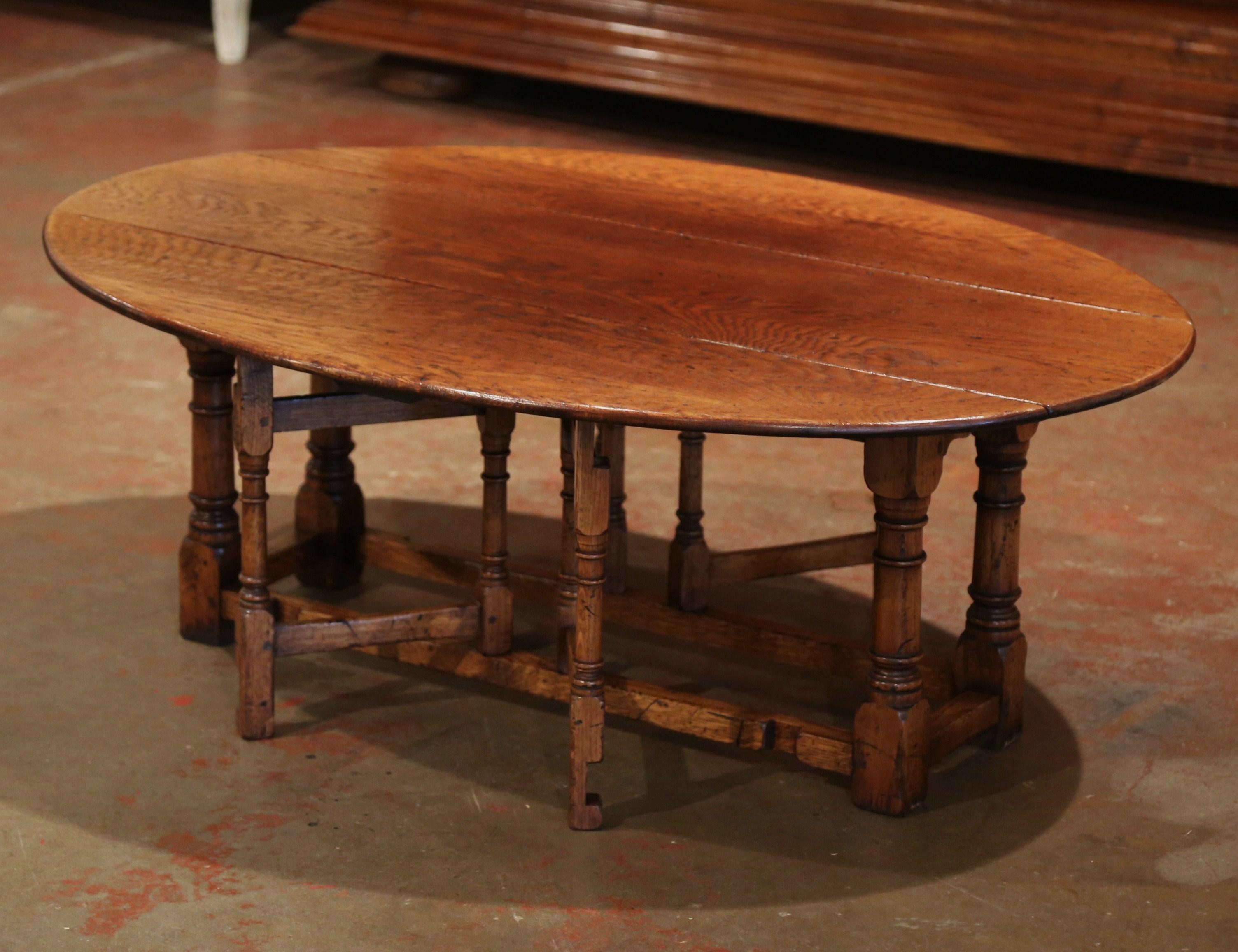 Place this versatile cocktail table in a living room, a den or a game room; crafted in England circa 1950 from solid chestnut, the table stands on four sturdy turned legs embellished with a decorative stretcher at the bottom. The table has four