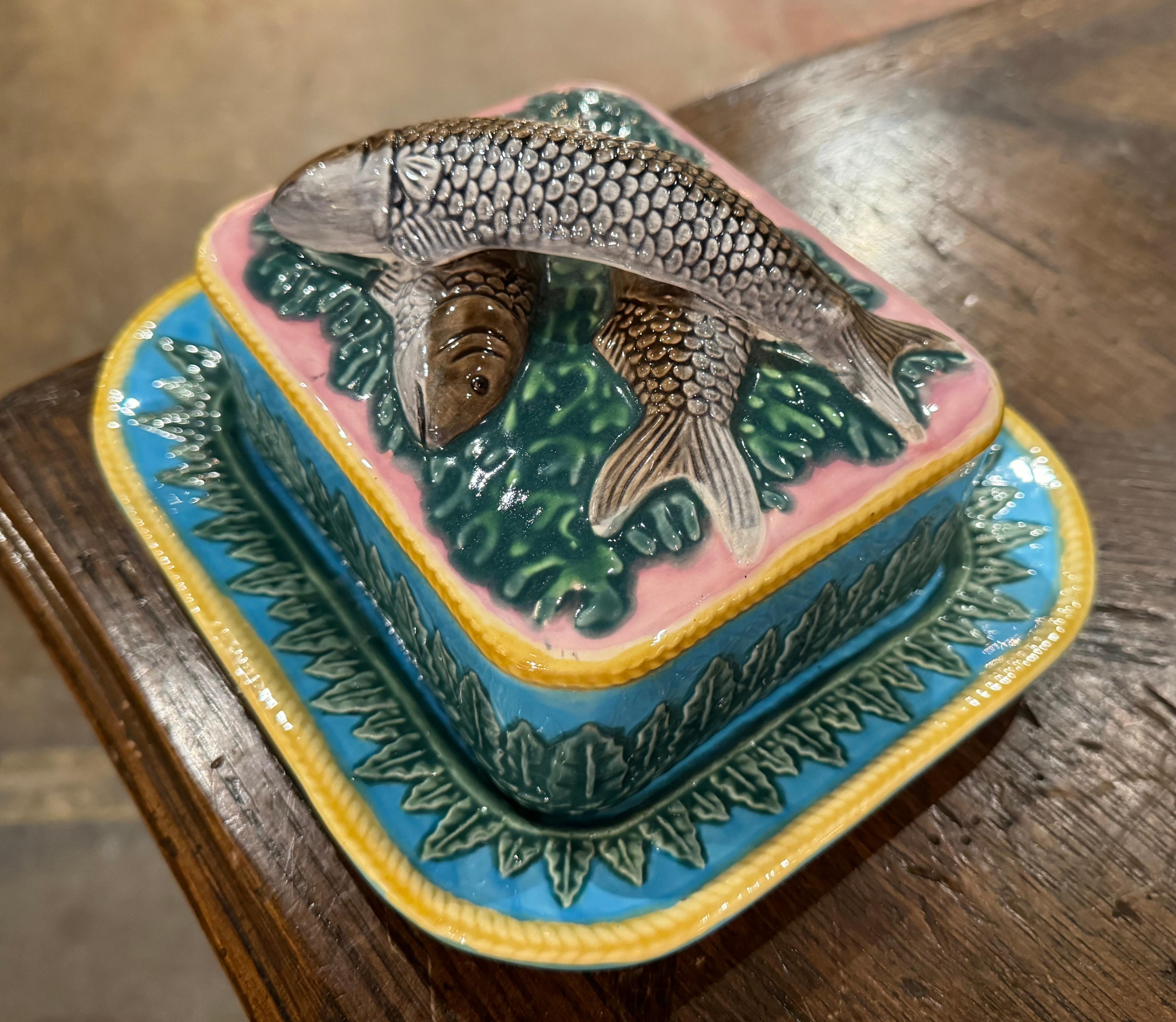 Decorate a shelf or kitchen counter with this colorful two-piece barbotine dish. Created in England circa 1960 and attributed to Georges Jones & Sons, the dish is rectangular in shape and sits on an attached platter base. The removable top features