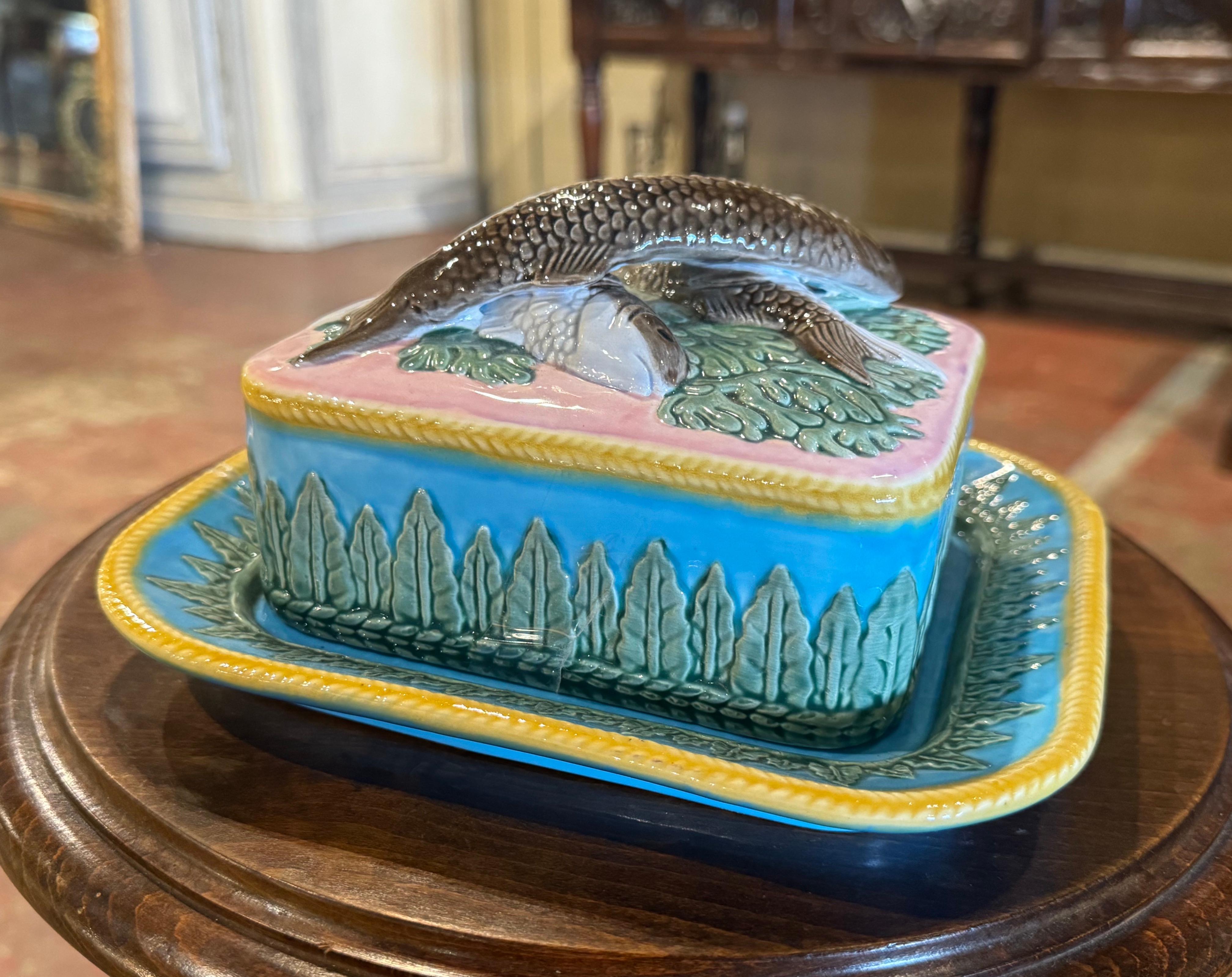 Decorate a shelf or kitchen counter with this colorful two-piece barbotine dish. Created in England circa 1960 and attributed to Georges Jones & Sons, the dish is rectangular in shape and sits on an attached platter base. The removable top features