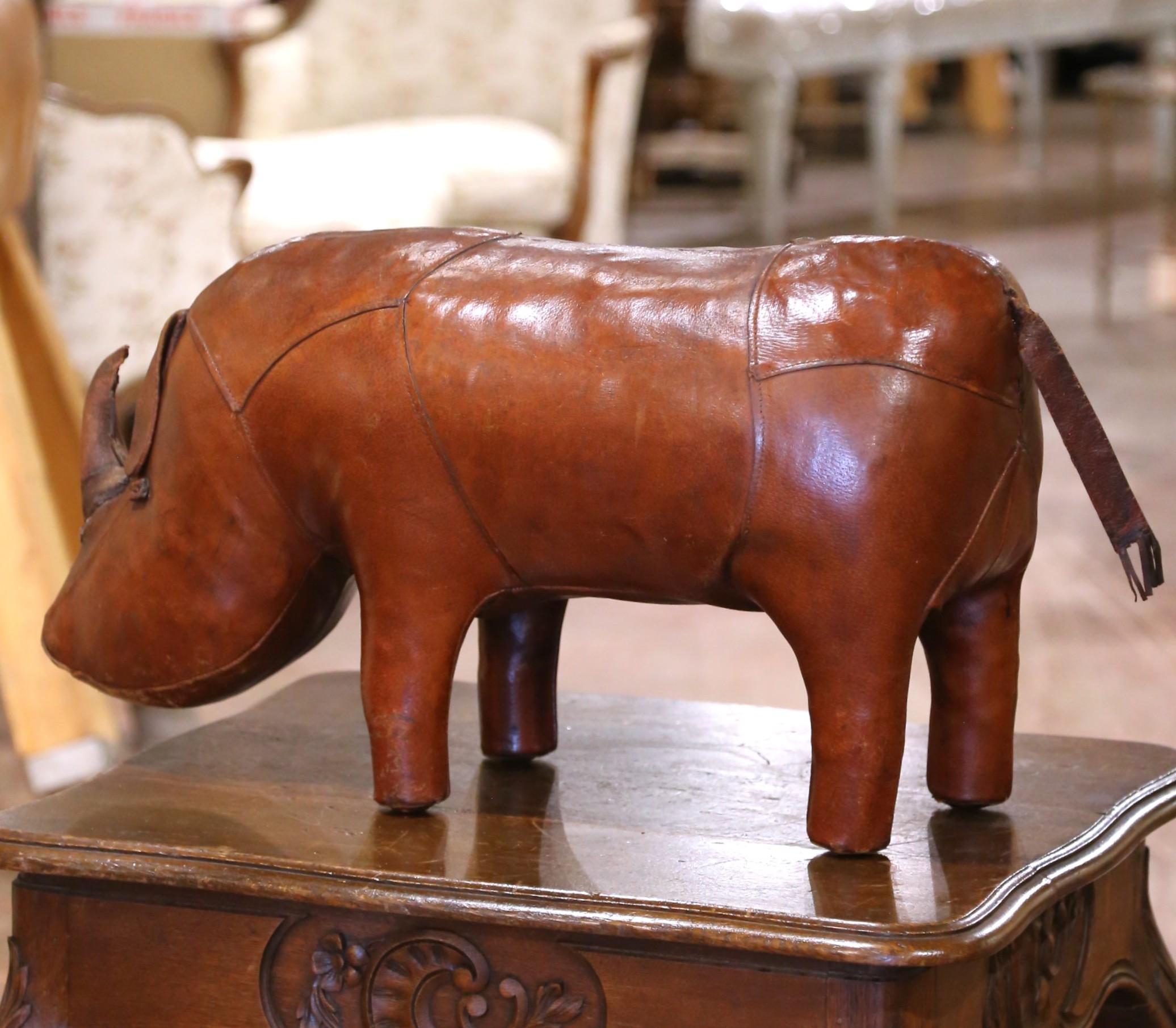 Bring charm, craftsmanship, and a touch of British wit to your interior with this mid-century leather rhinoceros, attributed to Dimitri Omersa for Abercrombie & Fitch. Handcrafted in England circa 1960, this sculptural piece is made from rich brown