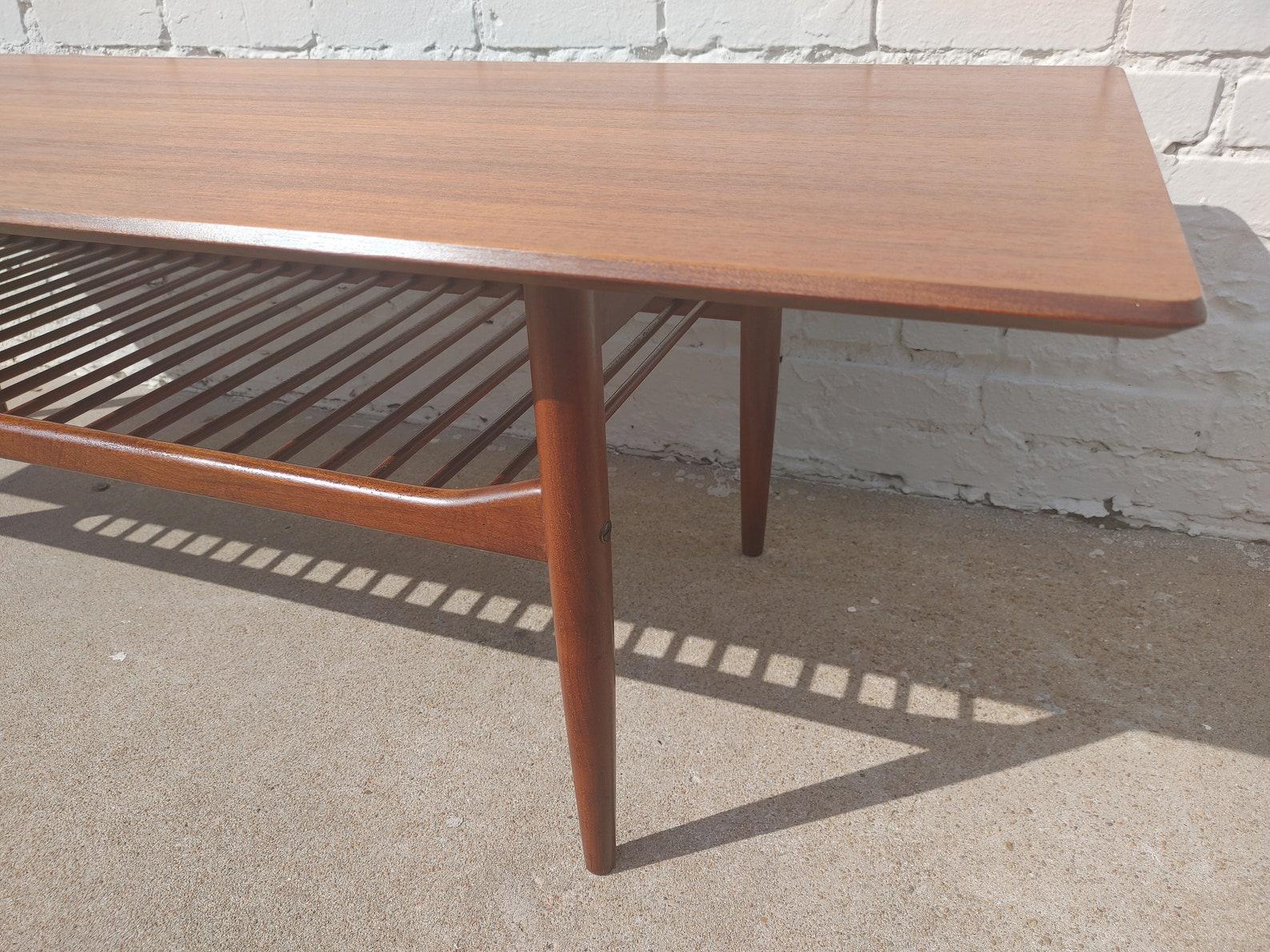 Mid Century English Modern Coffee Table by Kofod Larsen

Above average vintage condition and structurally sound. Has some expected slight finish wear and scratching. Tops have been refinished and do not have original factory finish. There are two of