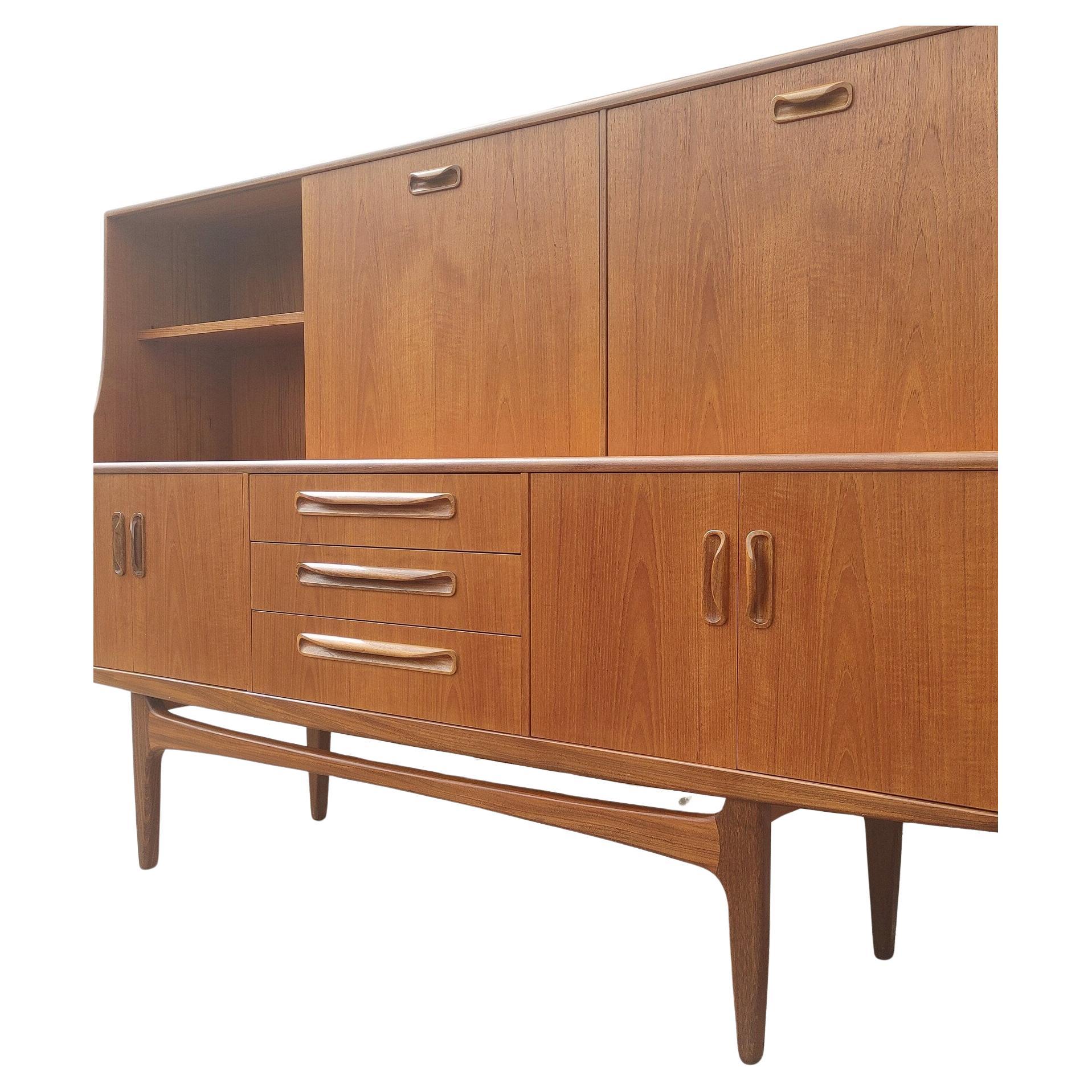 Mid Century English Modern G Plan Teak Hutch
 
Above average vintage condition and structurally sound. Has some expected slight finish wear and scratching. One area on left upper hutch has missing veneer. Outdoor listing pictures might appear