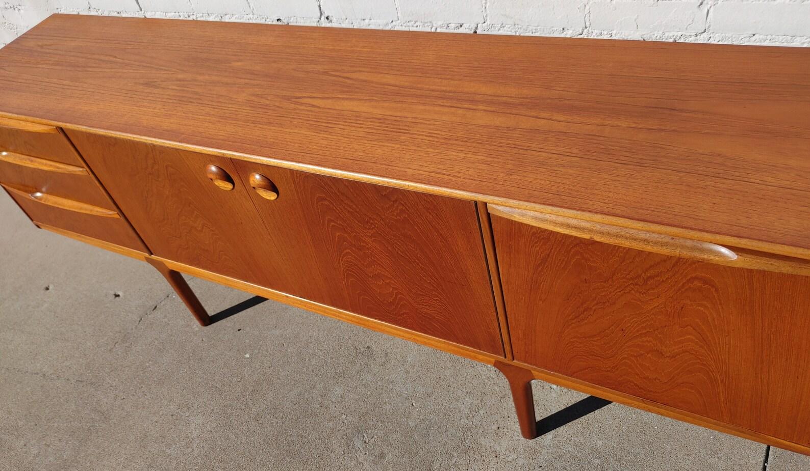 Mid Century English Modern Teak Sideboard by McIntosh

Average vintage condition and structurally sound. Has some expected finish wear, scratching, and discoloration. Top has been refinished and does not have original factory finish. Outdoor listing