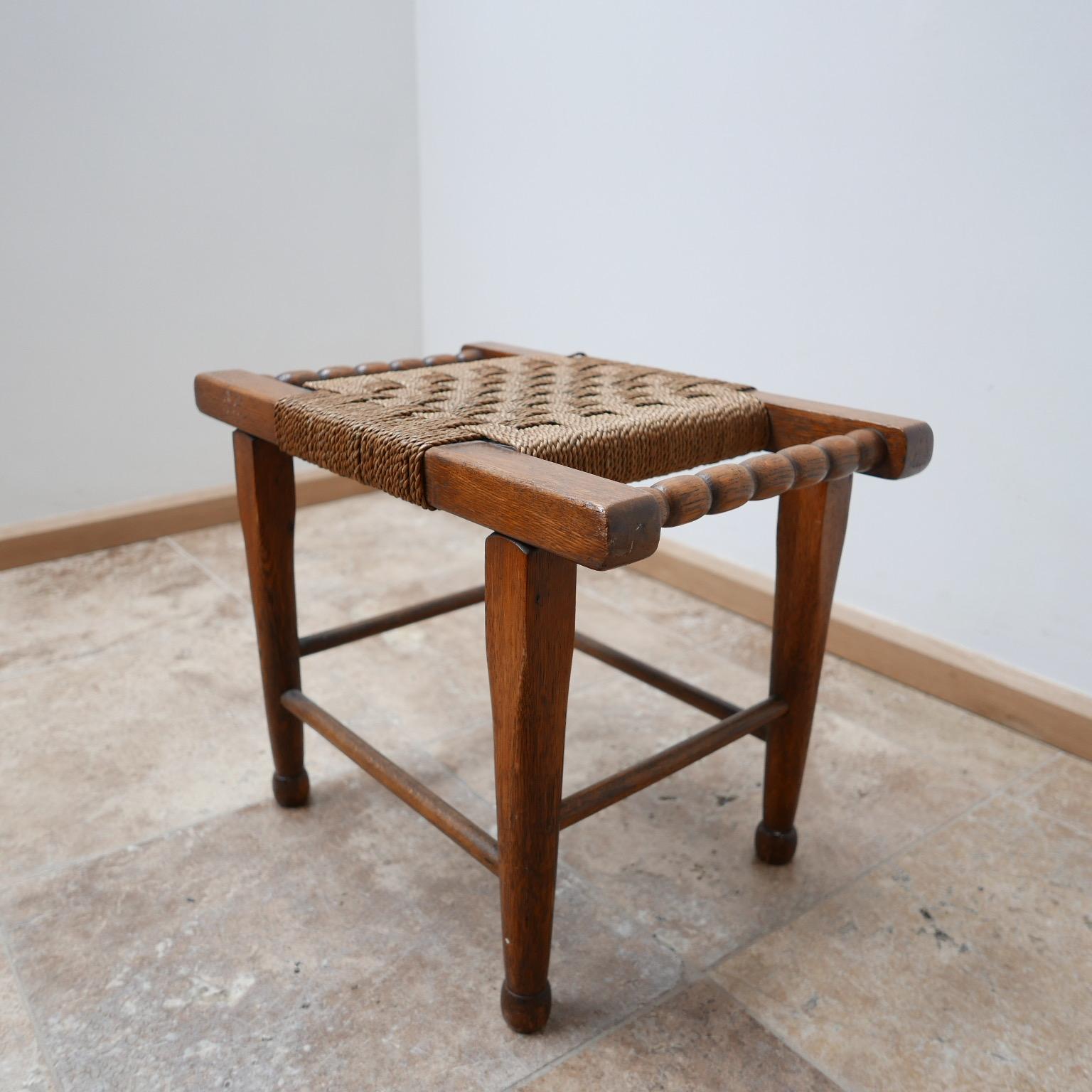 A good looking stool or side table.
England, circa 1950s.

Rope cord seat, two handles make it functional and stylish.

In good condition.

Dimensions: 51 width, 33 depth, 39.5 height, all in cm.