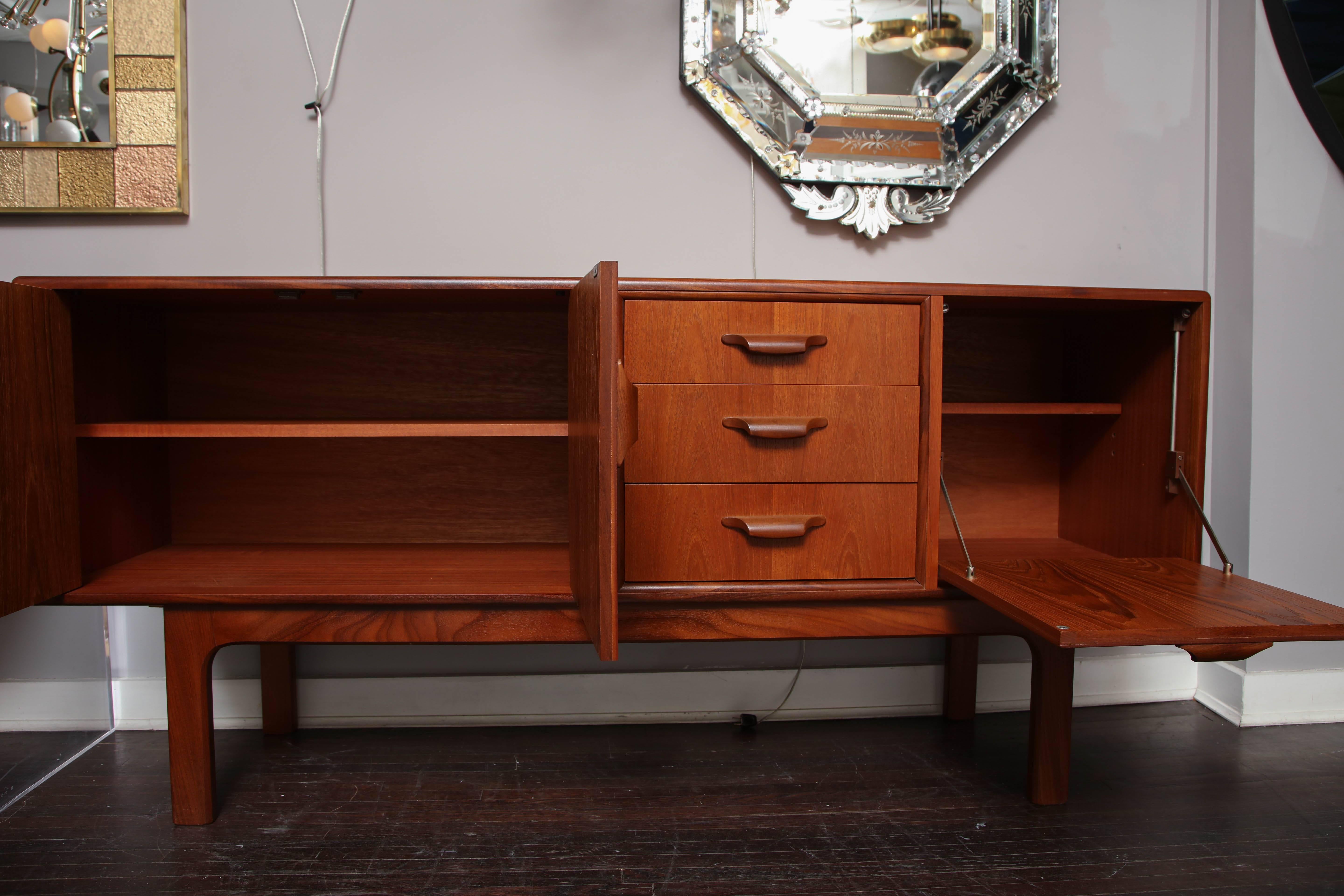 Midcentury English teak credenza. The piece is in good condition with some scratches and blemishes that are consistent with age and use. No issues on all the drawers and cabinet doors.