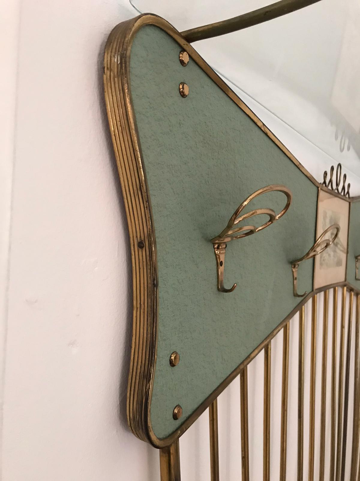 A beautiful midcentury Italian coat rack in brass with a glass top shelf and a signed and dated watercolor.