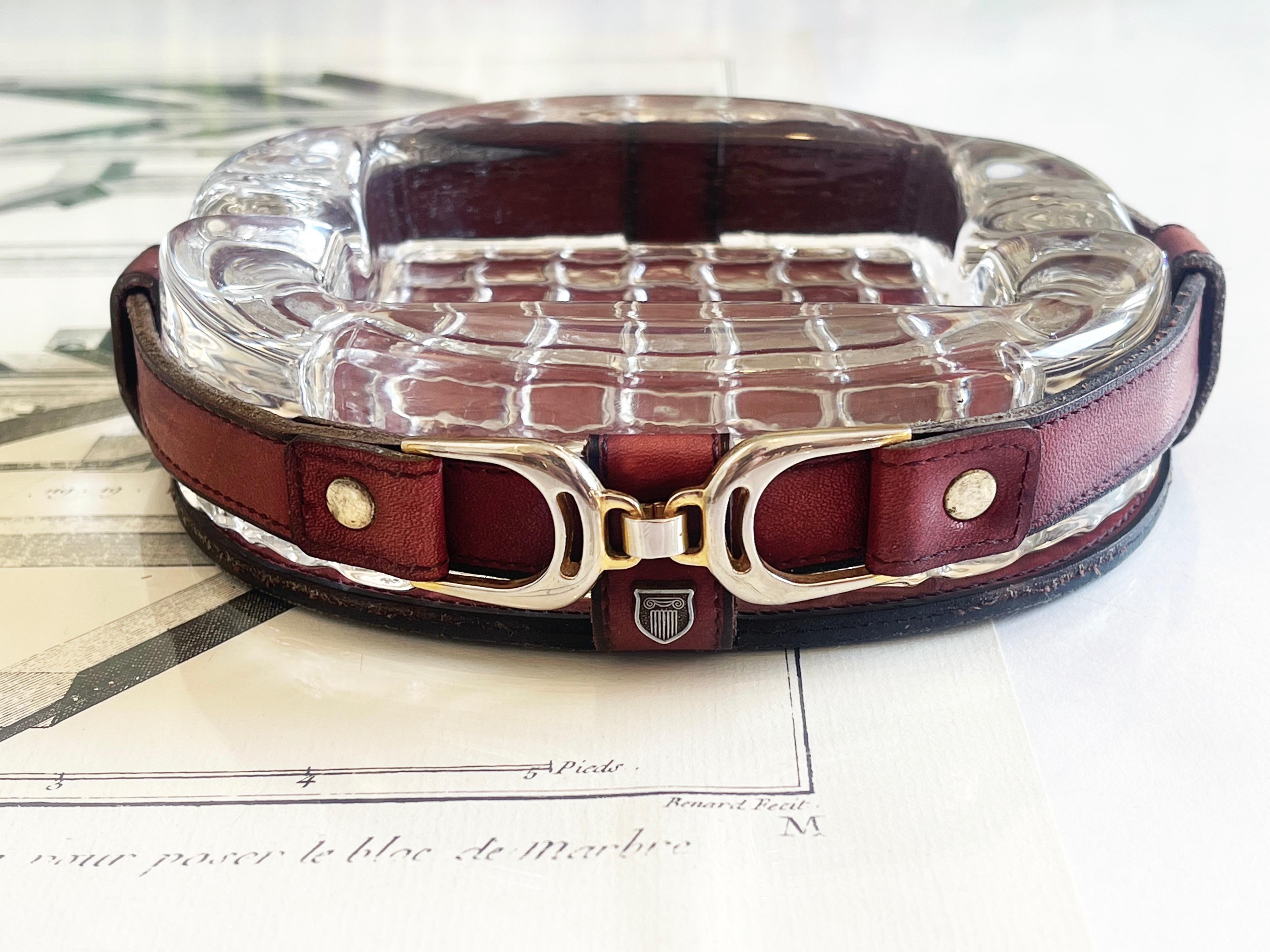 Posacenere vintage ovale, bello e robusto, realizzato in vetro trasparente, vera pelle e minuteria metallica con una tonalità dorata.
Realizzato negli anni '70 in Germania, interpreta gli am designs di Hermes e un po' di Jacques Adnet dando al pezzo