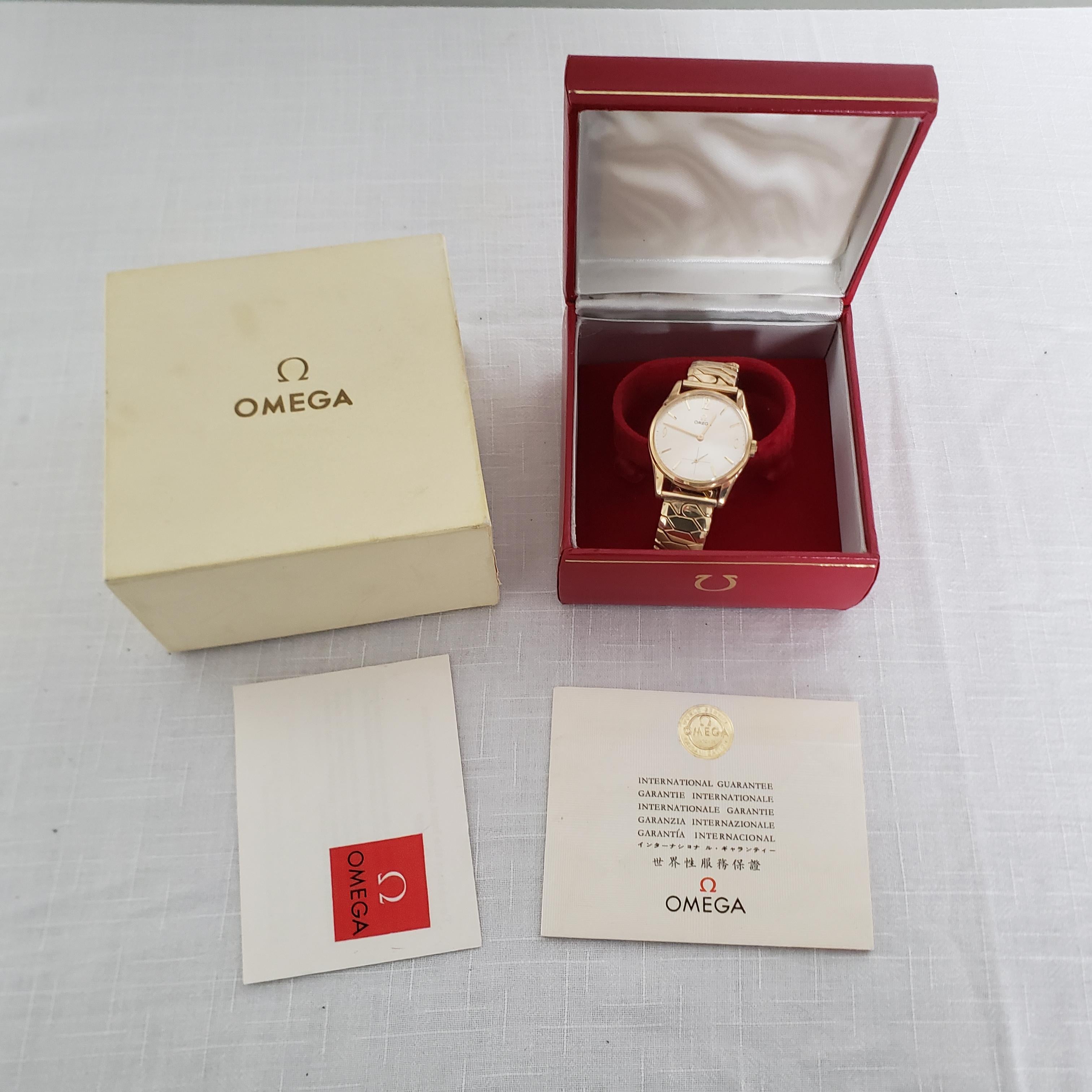 This 9-karat yellow gold men's wristwatch was made by the highly renowned Omega watch company of Switzerland in approximately 1965 in the period Mid-Century Modern style. The watch is in new/old stock condition showing no scratches or significant