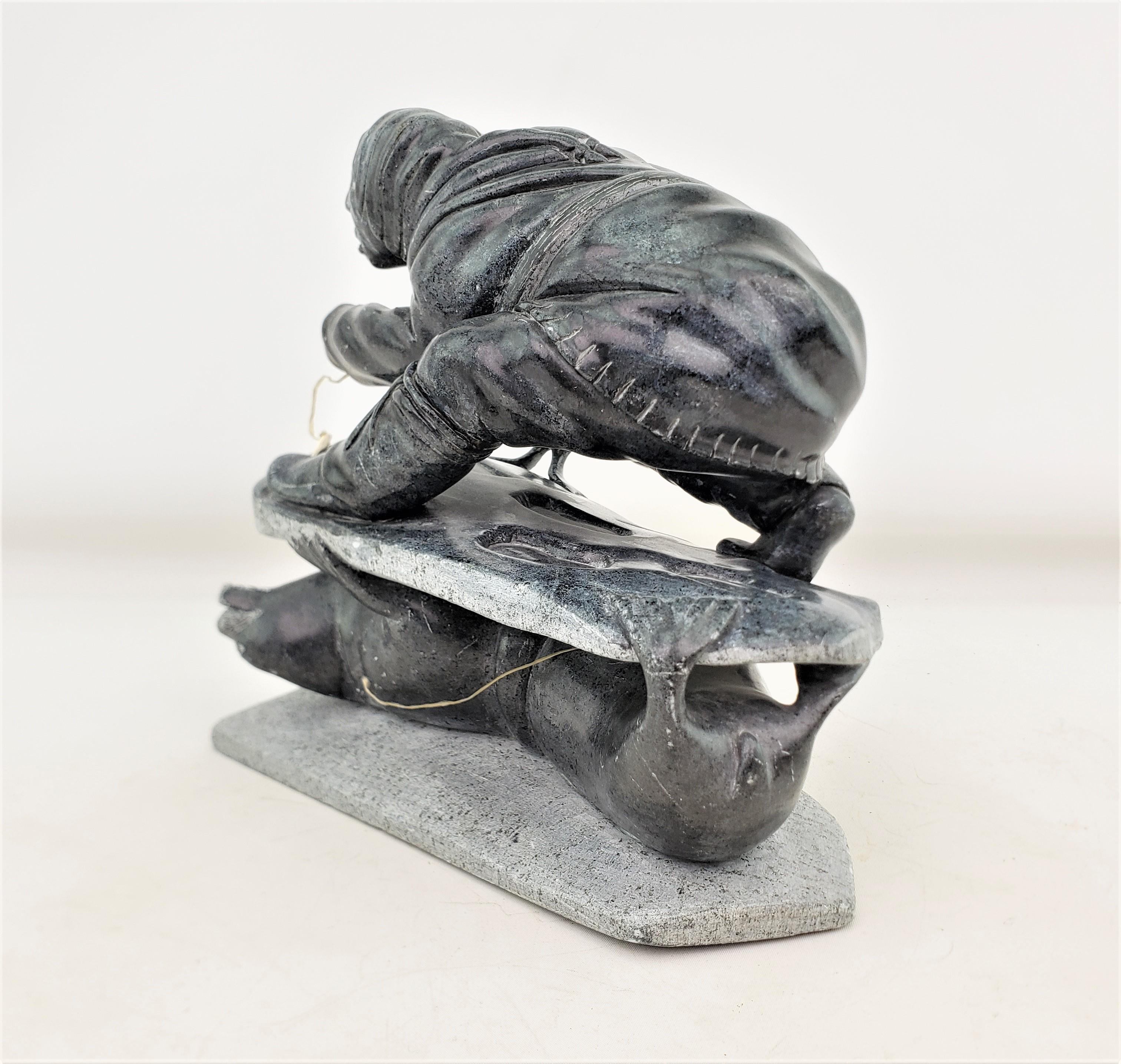 Canadian Midcentury Era Akulivik Region Inuit Soapstone Carving of a Man Seal Hunting For Sale