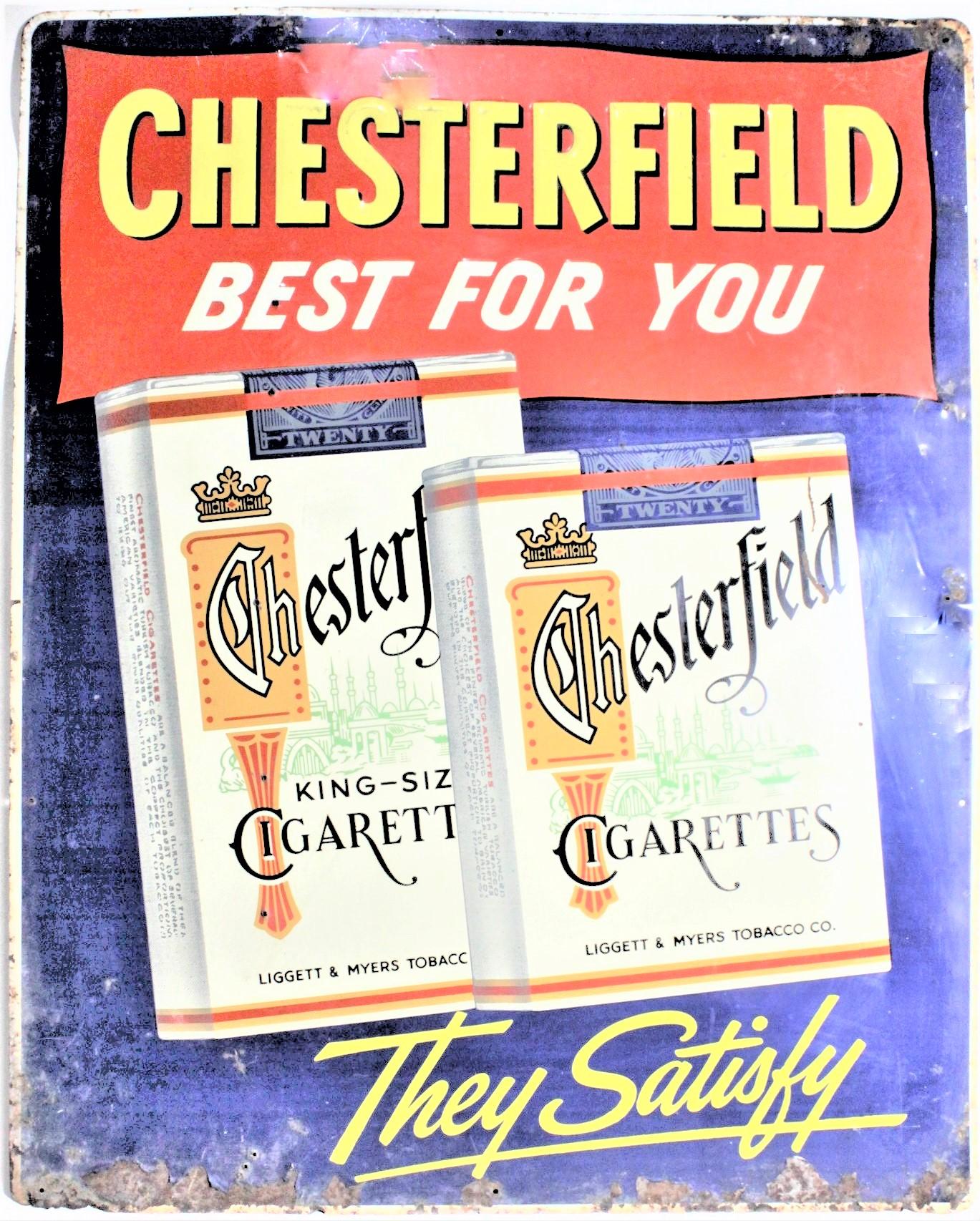 This midcentury period embossed and painted tin advertising sign was made for the Liggett and Myers Tobacco Company in circa 1965 to promote their Chesterfield cigarette brand. The sign is done in very vibrant colors and shows several packages of