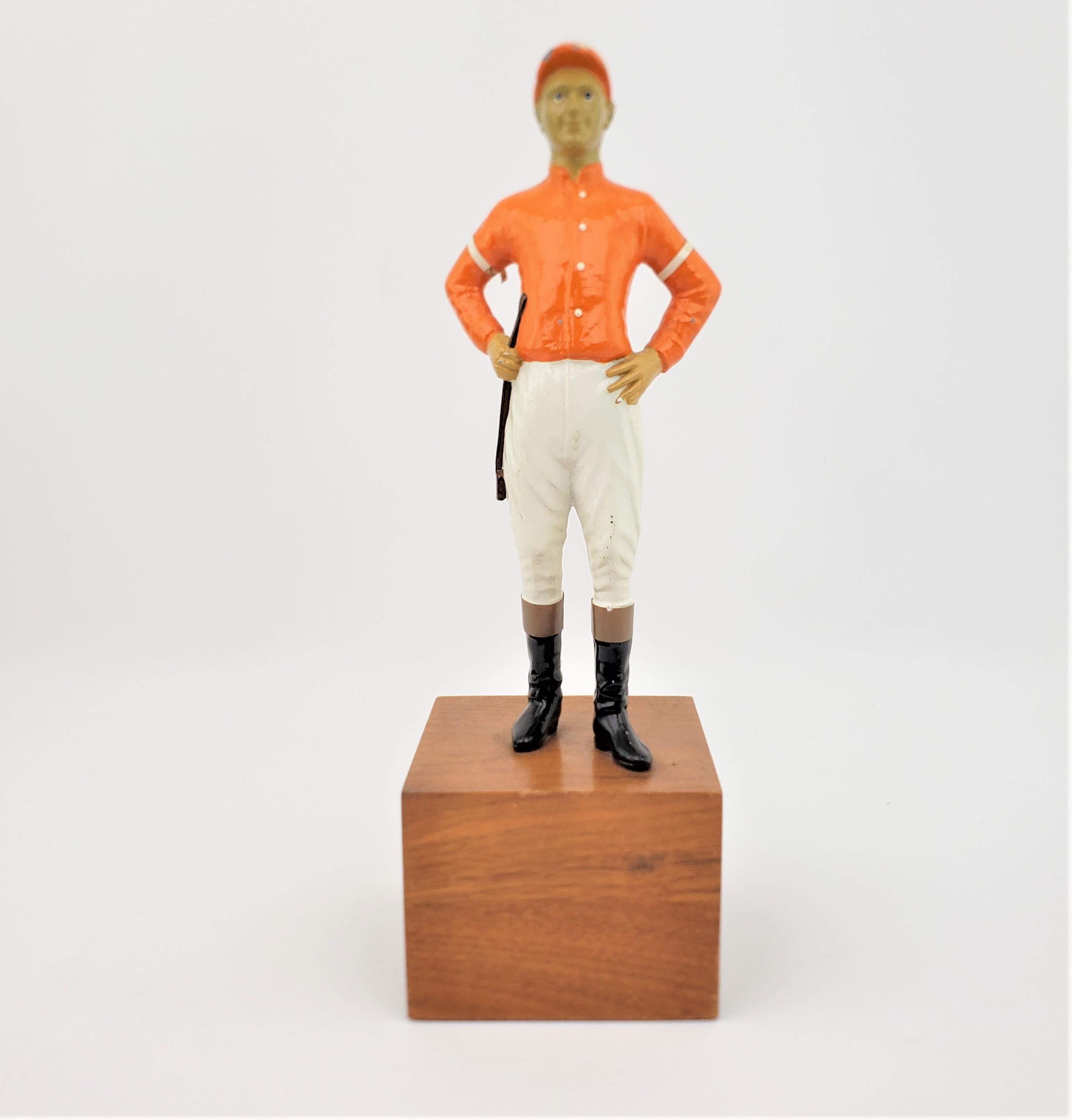 This cast and cold painted spelter horse jockey sculpture is unsigned, and presumed to have been made in the United States in approximately 1960. The sculpture may be a tribute to a famous jockey of the time, but we were not able to identify who it