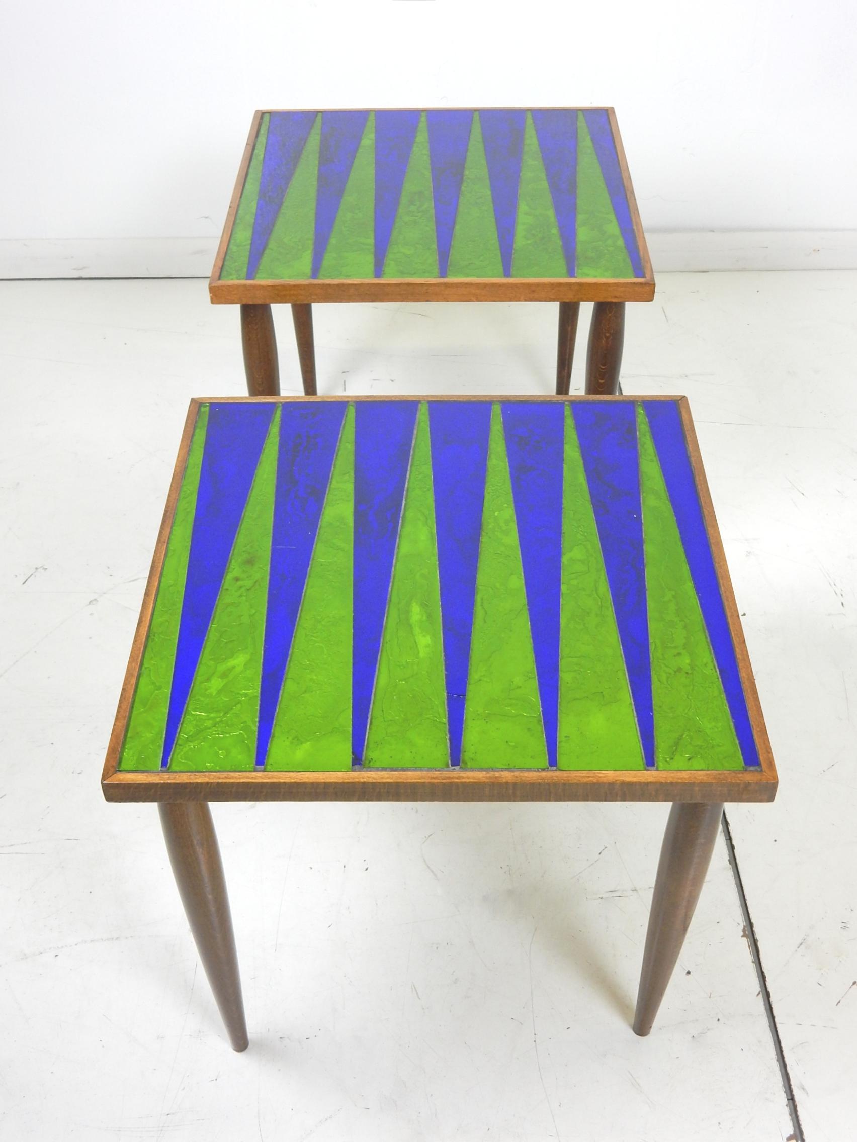 Mid Century era Georges Briard designed glass mosaic side tables.
Gorgeous blue and green glass top framed in walnut with matching tapered legs.
Both are in excellent condition showing very little wear or use.