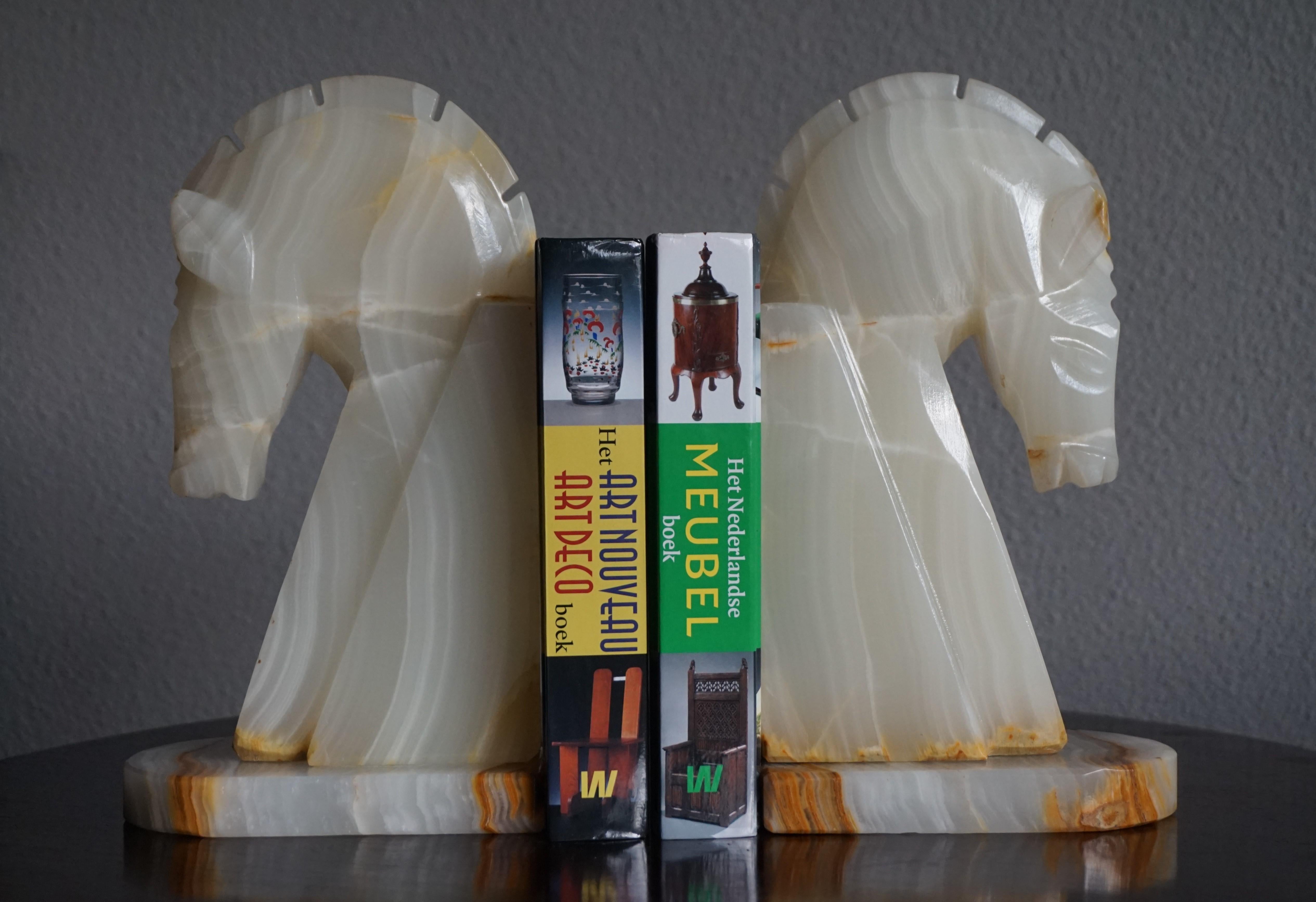 Beautiful, practical and decorative, mineral stone bookends.

The shape of these stunning horse bookends resembles that of chess pieces and their geometrical design is very much Art Deco in style. Because of their design and colors they will look