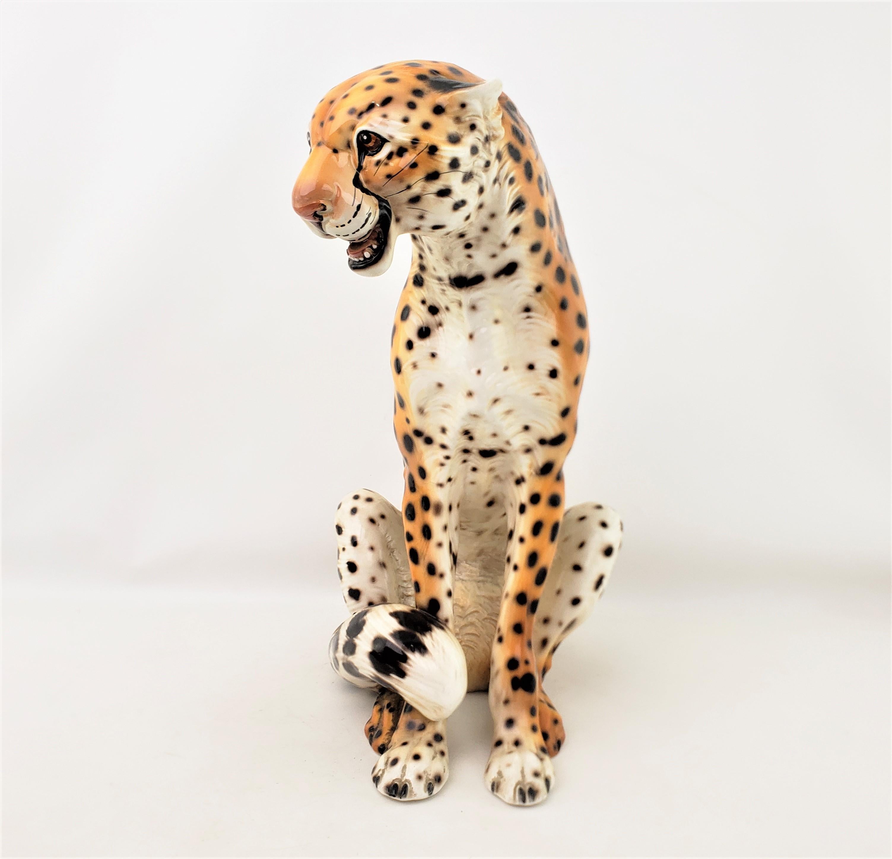 This sizable ceramic and well executed Cheetah sculpture is signed by the maker Ronzan of Italy and dates to approximately 1960 and done in the period Mid-Century Modern style. The sculpture is done in a detailed molded ceramic which has been