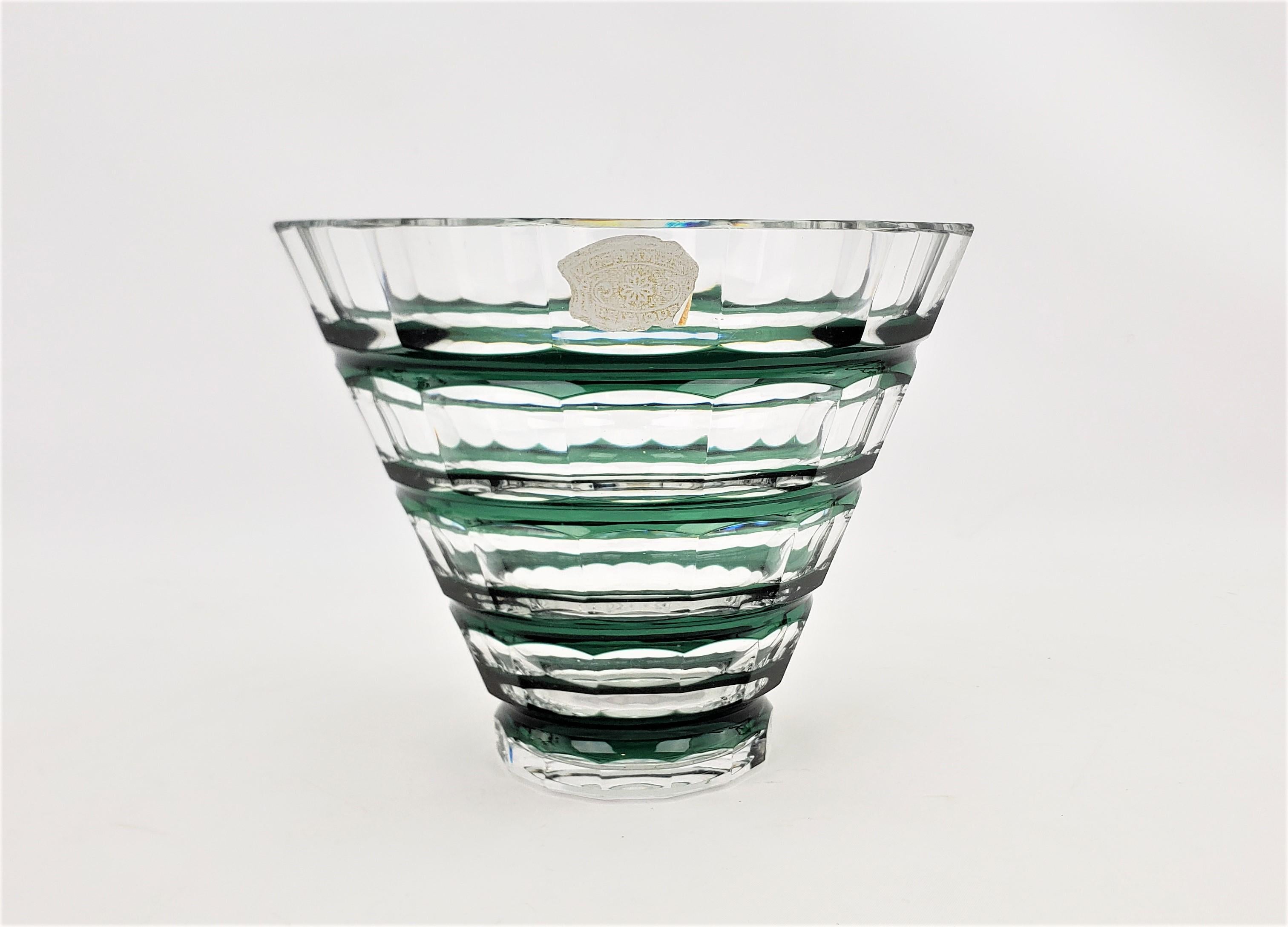 This cut crystal vase or bowl was made by the renowned Belgian glass factory of Val Saint Lambert in approximately 1965 in a period Mid-Century style. The bowl is done in a clear crystal glass with a deep green banded accents. The vase is signed