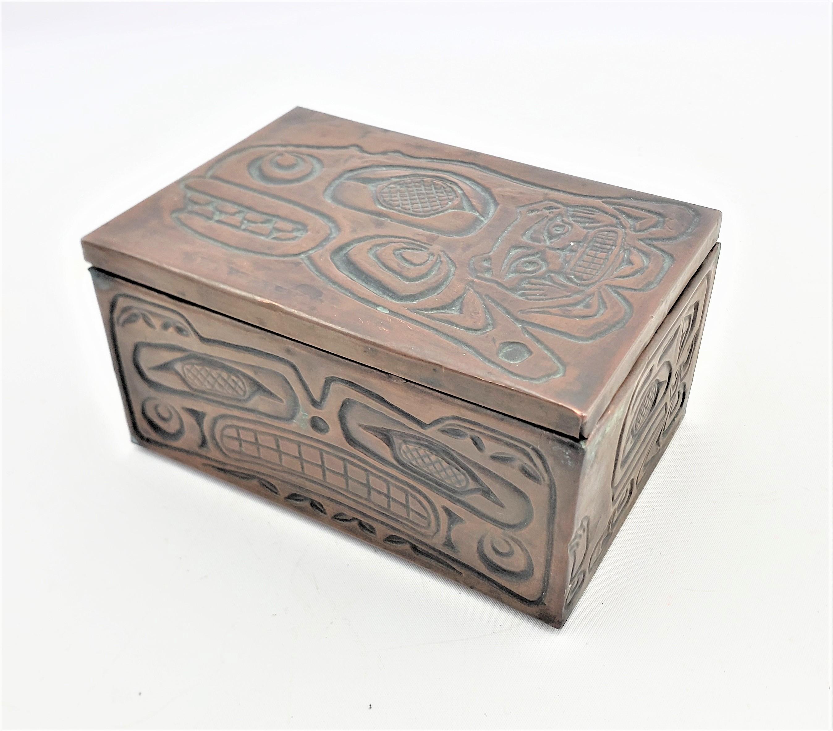 This small hand-crafted decorative or jewelry box is unsigned, but presumed to have originated from Canada, dating to approximately 1960 and done in the West Coast Haida style. The box is composed of wood, likely cedar, which has been covered with