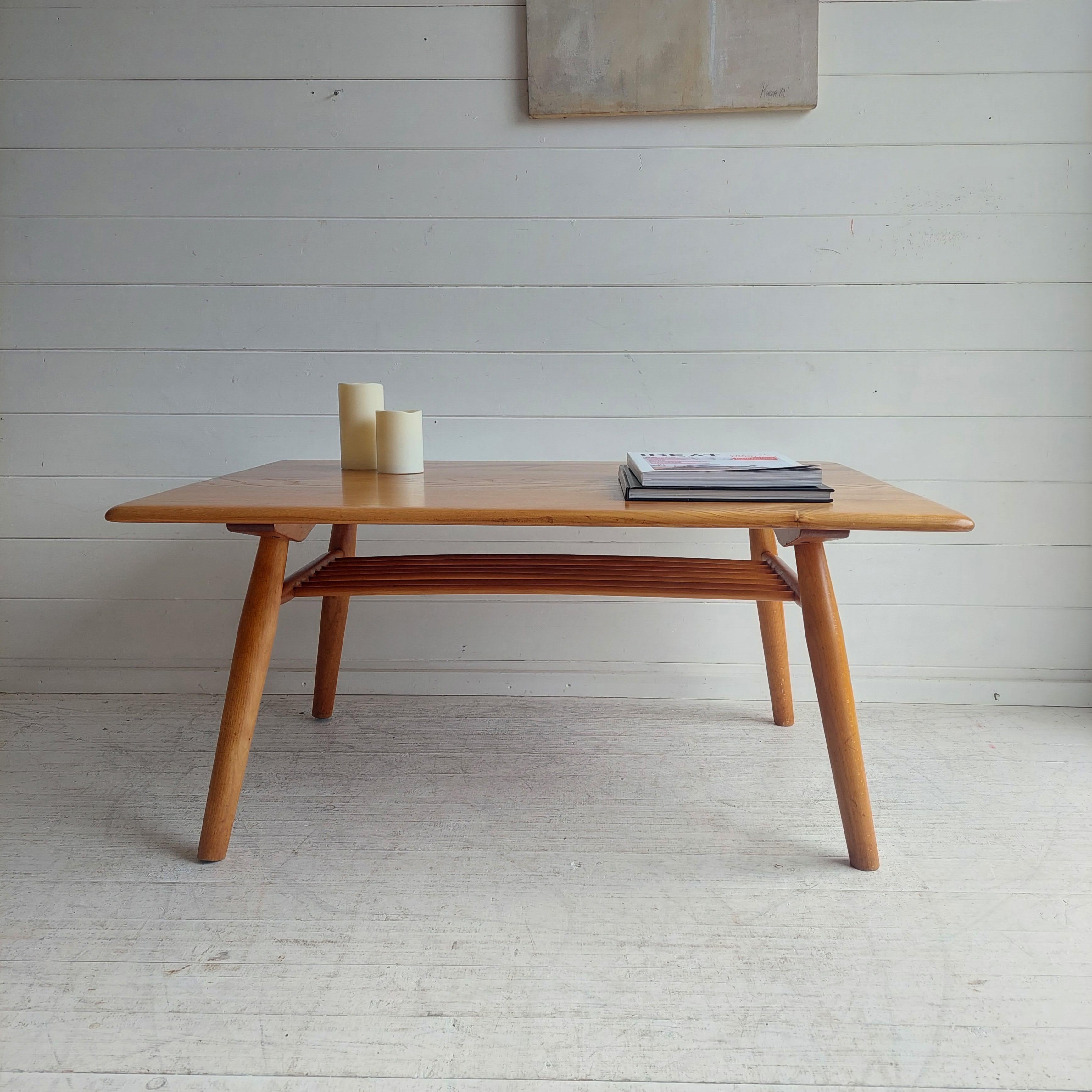 Unique repurposed Rare model 393 breakfast table into a coffee table.
Designed by Lucian Ercolani in the 1950/60s for Ercol.

Desirable rectangular coffee table with rounded edges and functional spindle wood magazine shelf underneath.
The legs and